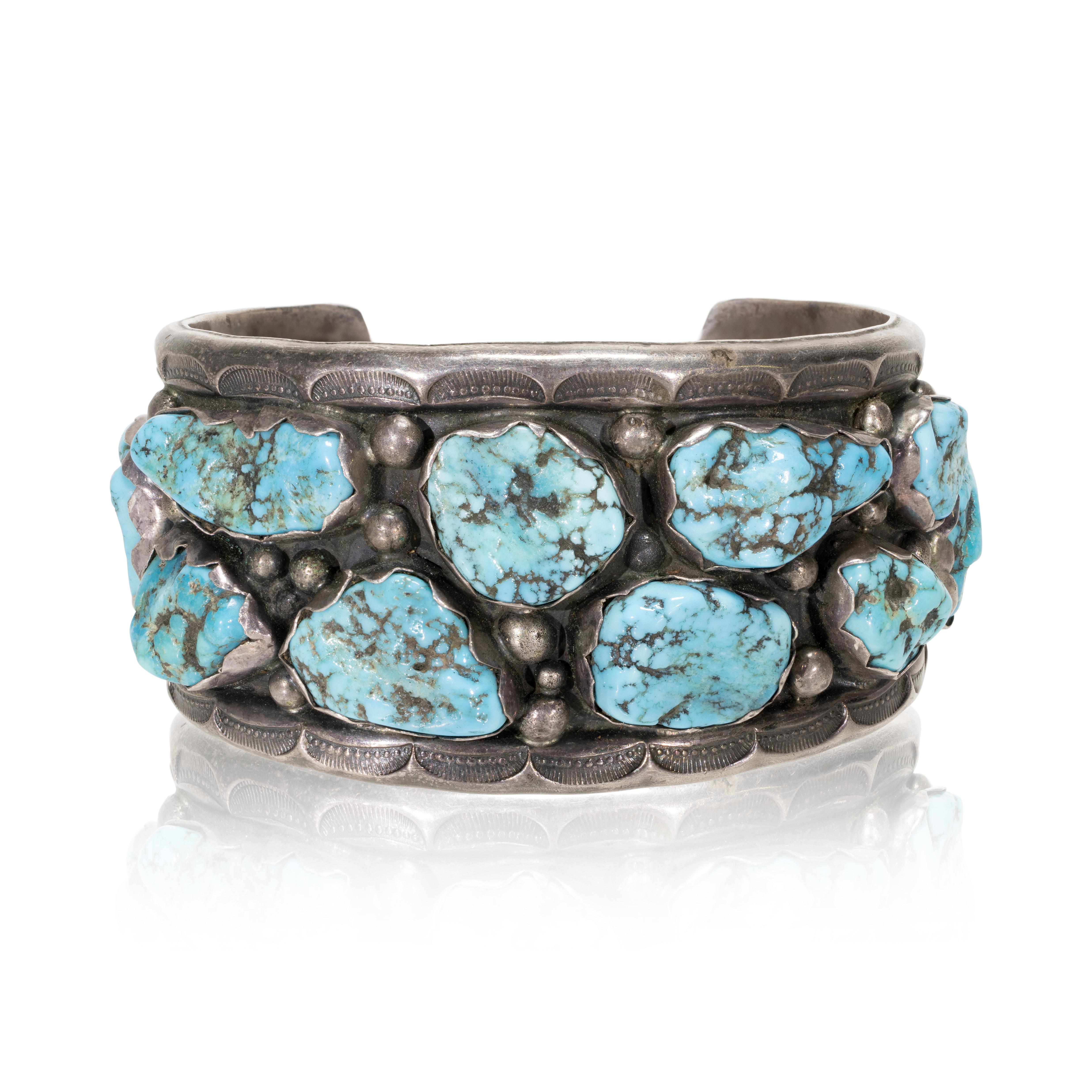 Navajo Kingman turquoise cuff bracelet. Two rows of turquoise nuggets interspersed with sterling beads in shadow box design detailed with hand stamped palmettos. Maker's mark 