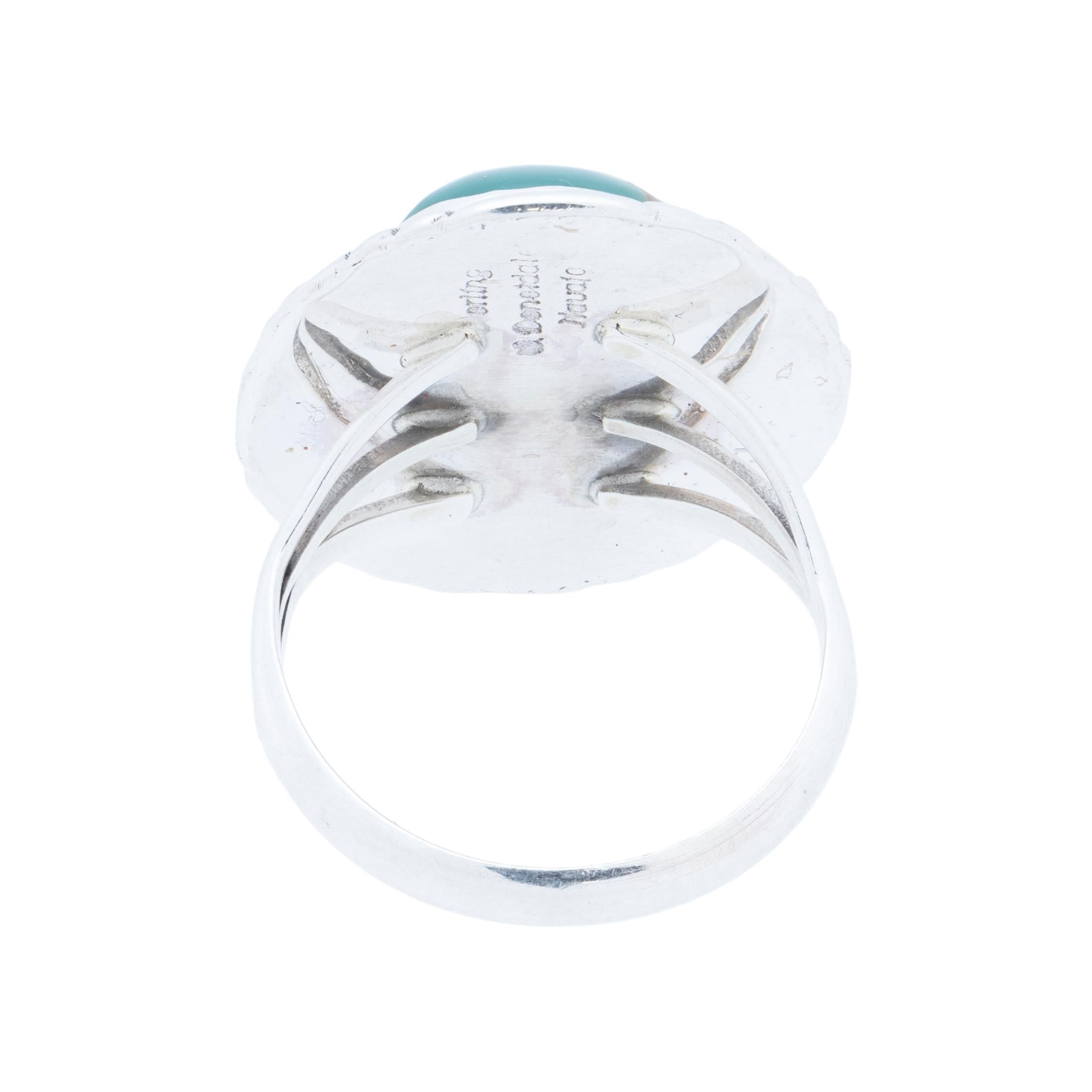 Navajo sterling silver and Kingman turquoise ring. Natural, untreated stone atop a classic twisted rope border with slash marks and hand stamped palmettes. Made by Navajo Silversmith W. Will Denetdale and stamped 