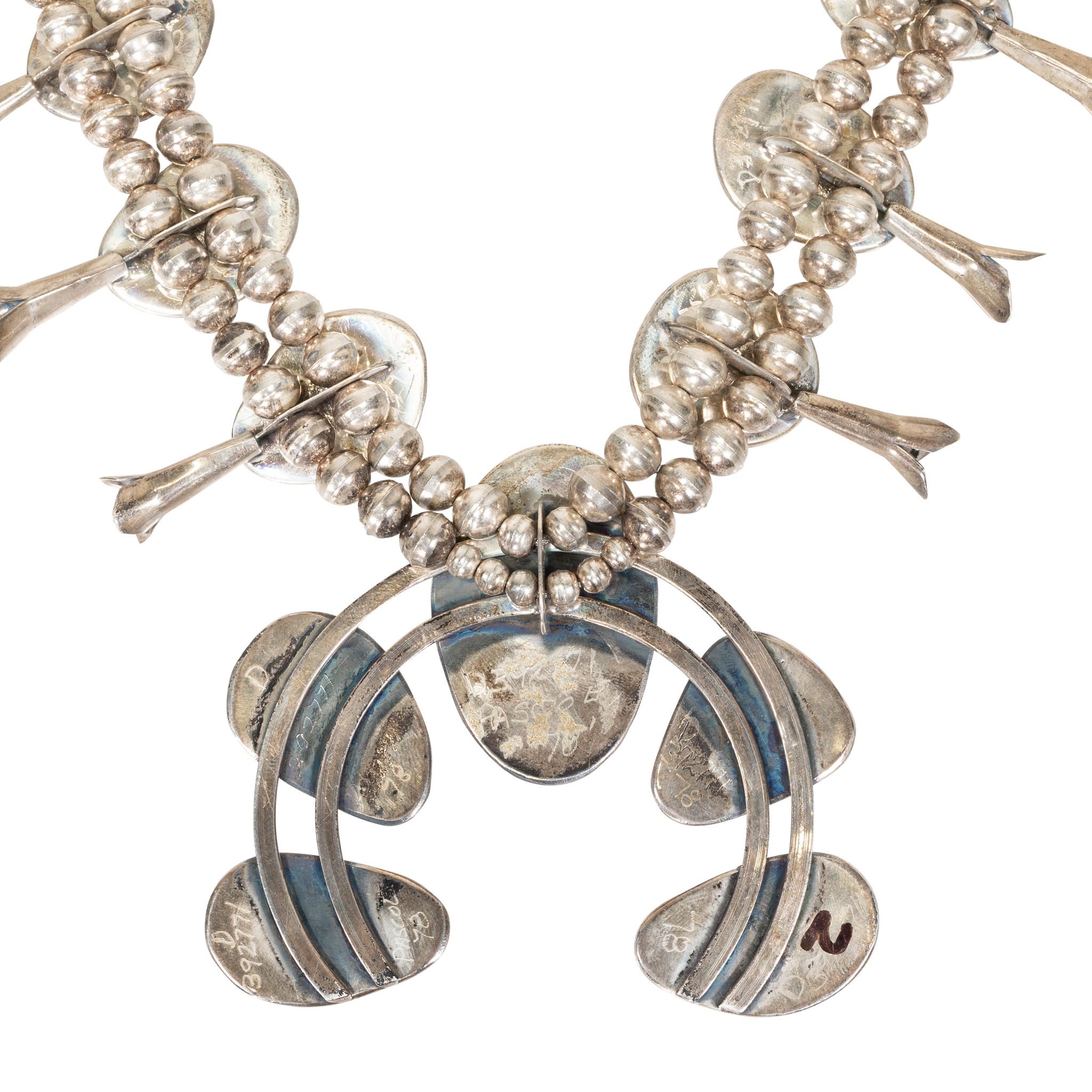 Kingman Mine squash blossom necklace on Navajo beaded chain. Featuring eight large nuggets of stunning turquoise on chain and five on naja, with center stone larger than others. Turquoise has raw, semi polished finish with bright blue and teal