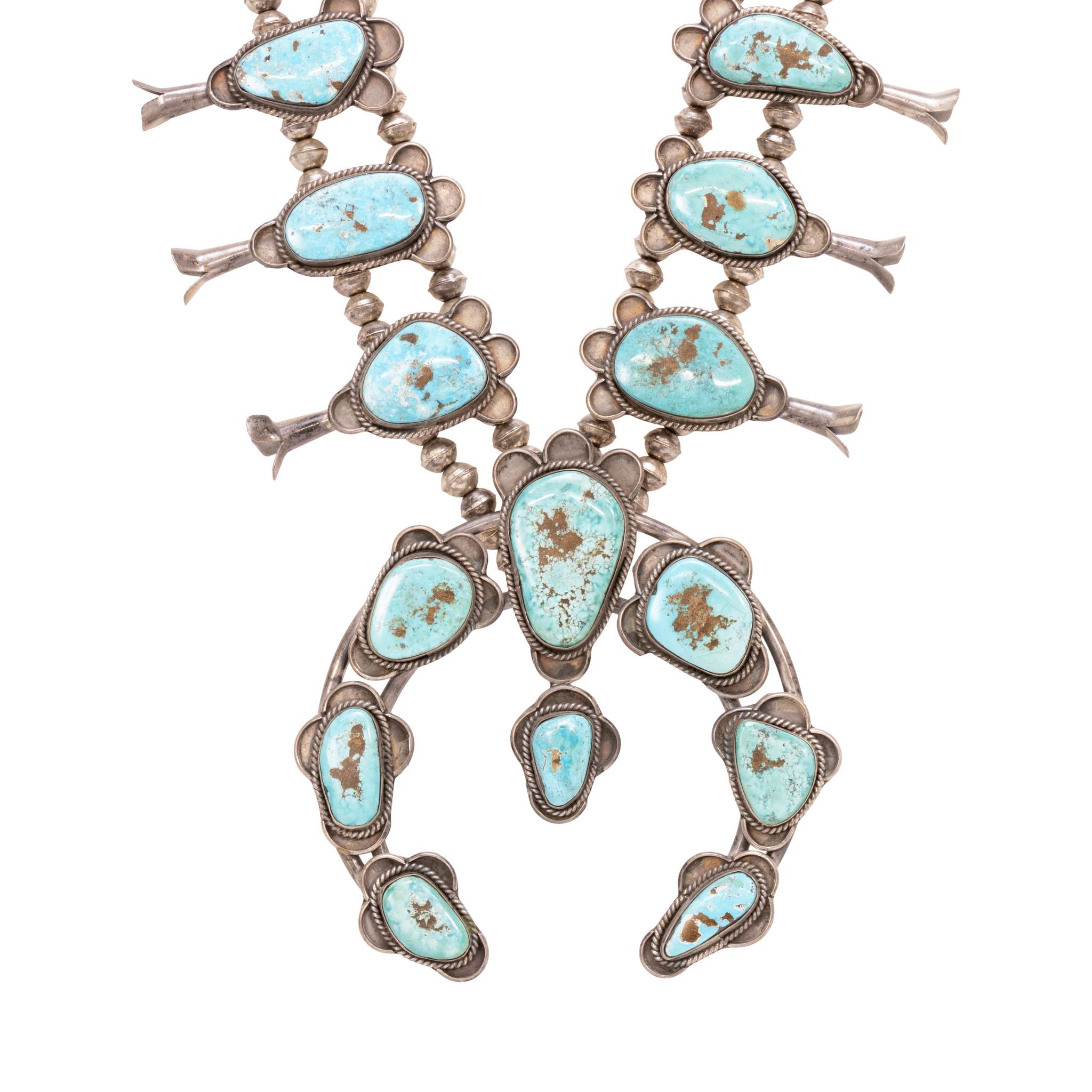 Navajo squash blossom necklace. Hand stamped silver Navajo pearls with seventeen exceptional stones of Kingman mine turquoise. Stones having bright blue color with brown and gold matrix, each surrounded by simple sterling scalloped border. Old Pawn.