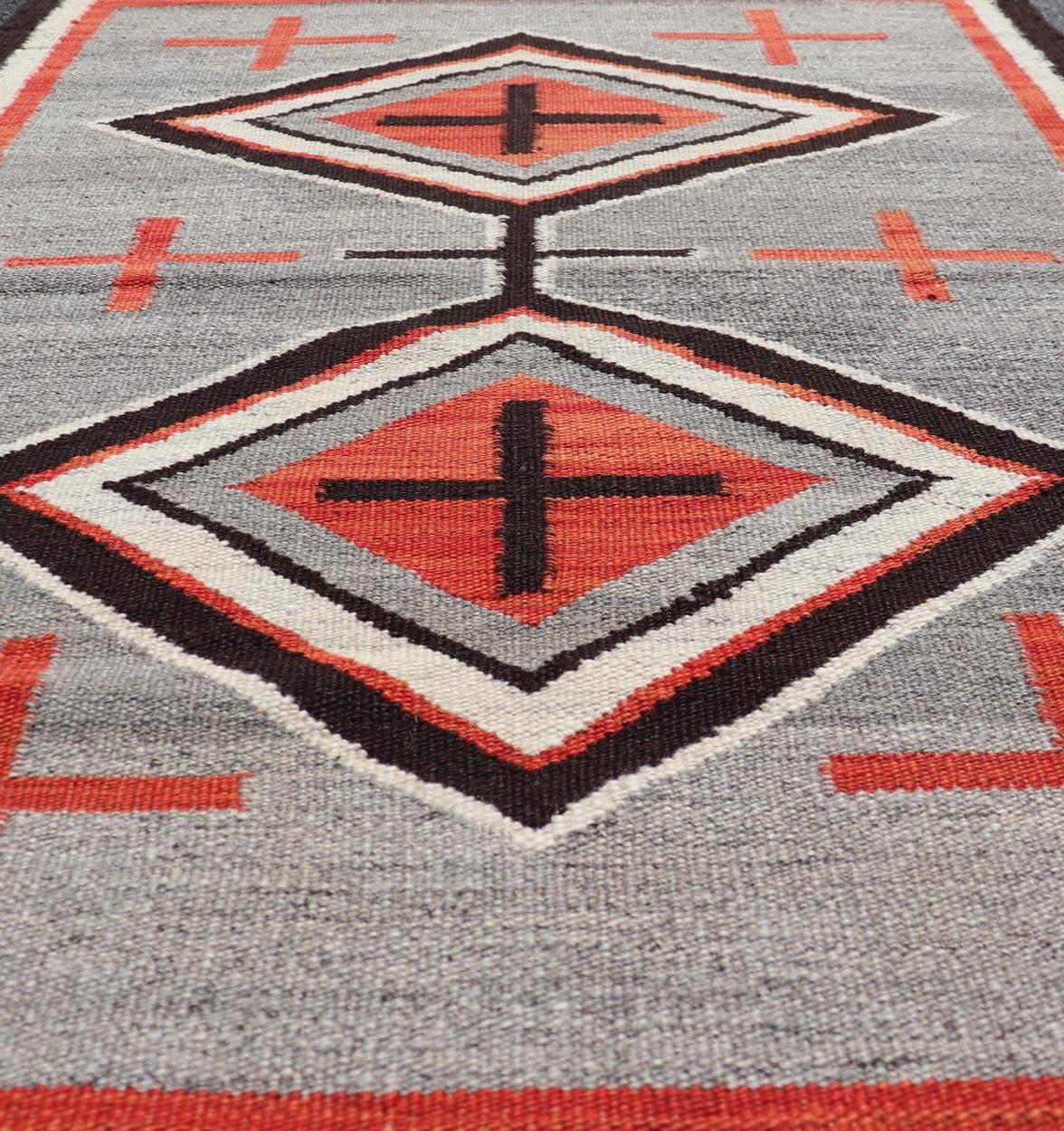 Navajo Modern Rug with Geometric Tribal Design in Gray, Red, Charcoal And Ivory. Keivan Woven Arts / rug RSC-86503-AR-163, country of origin India, type: North America / Navajo, circa early 21st century. 
Measures: 3'1 x 4'11 
This intriguing