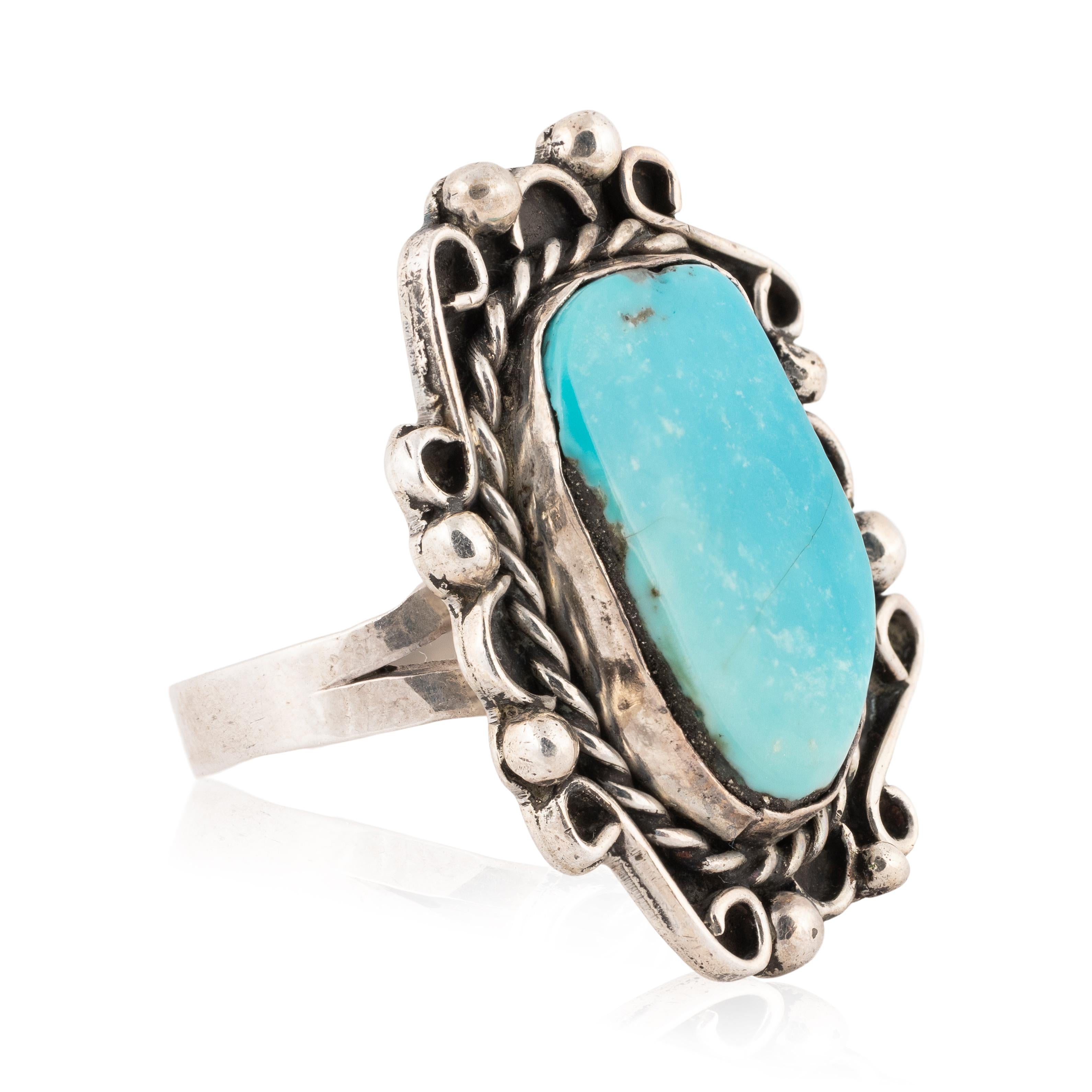 
Navajo Morenci mine turquoise and sterling ring. Center stone set in shadow box design with twisted rope and bead border. Nice patina and shows age. 

PERIOD: After 1950

ORIGIN: Navajo, Southwest

SIZE: Size 8.7; 1.25