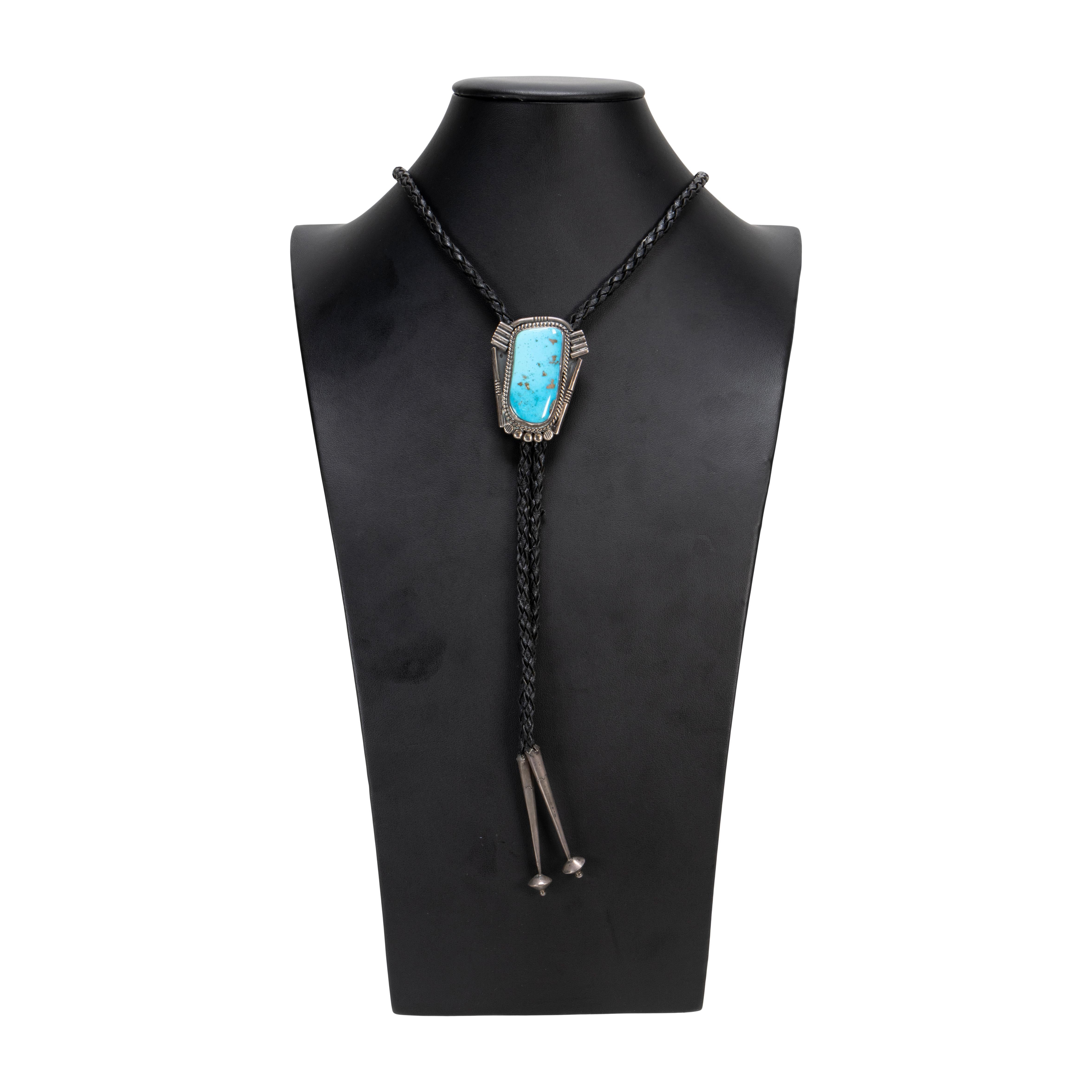 Navajo Morenci turquoise and sterling bolo tie. Nice sized stunning, natural and untreated stone surrounded by classic twisted rope border and shadowbox. No Maker's mark.

PERIOD: Mid 20th Century
ORIGIN: Southwest - Navajo, Native American
SIZE: 2