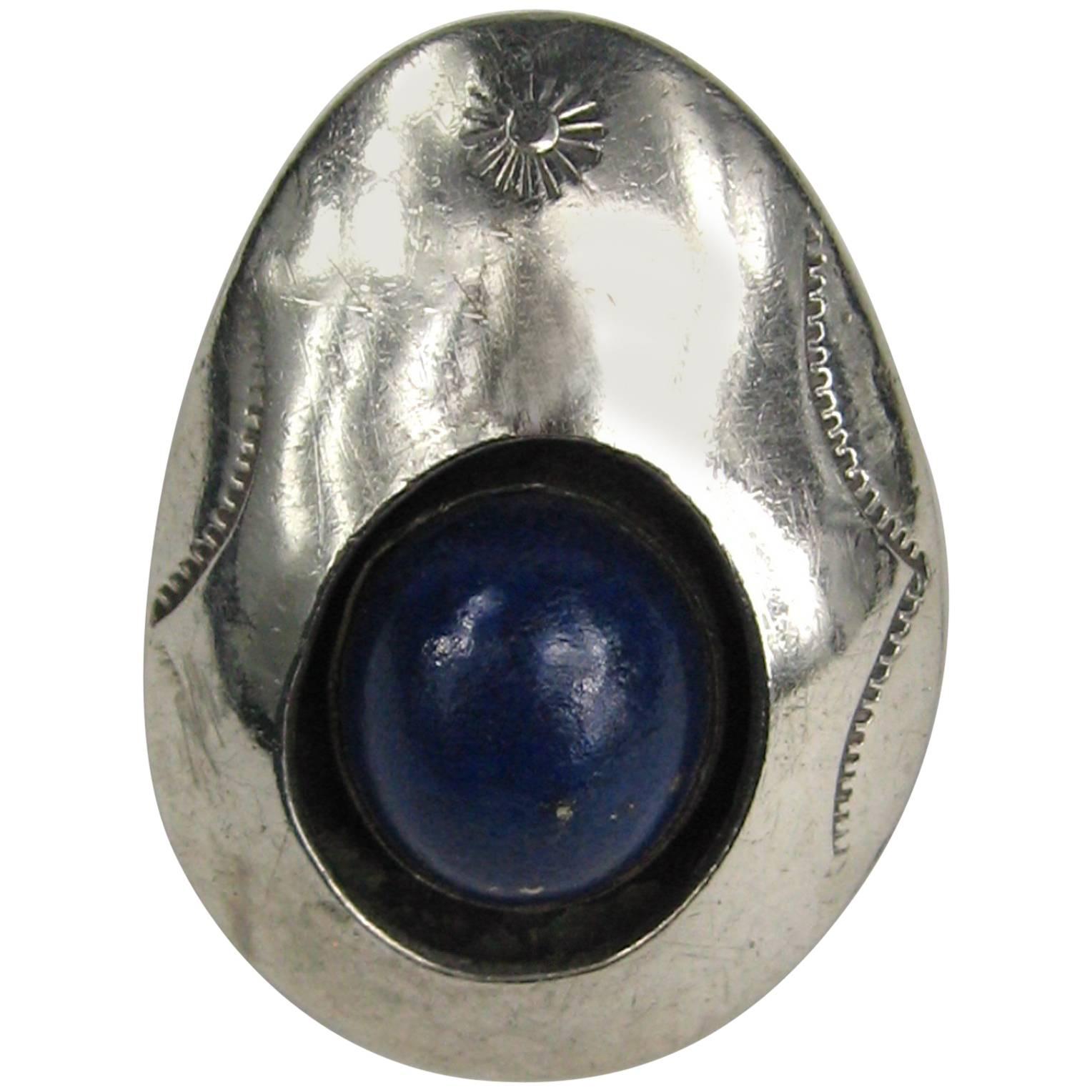 This is an amazing piece of Navajo Jewelry!  Lapis lazuli Shadow Box Sterling silver Ring.  Large Lapis stone inset in a shadow box of sterling  Matching earrings and squash blossom  necklace are listed as well on our storefront. Ring is a 5.25 top