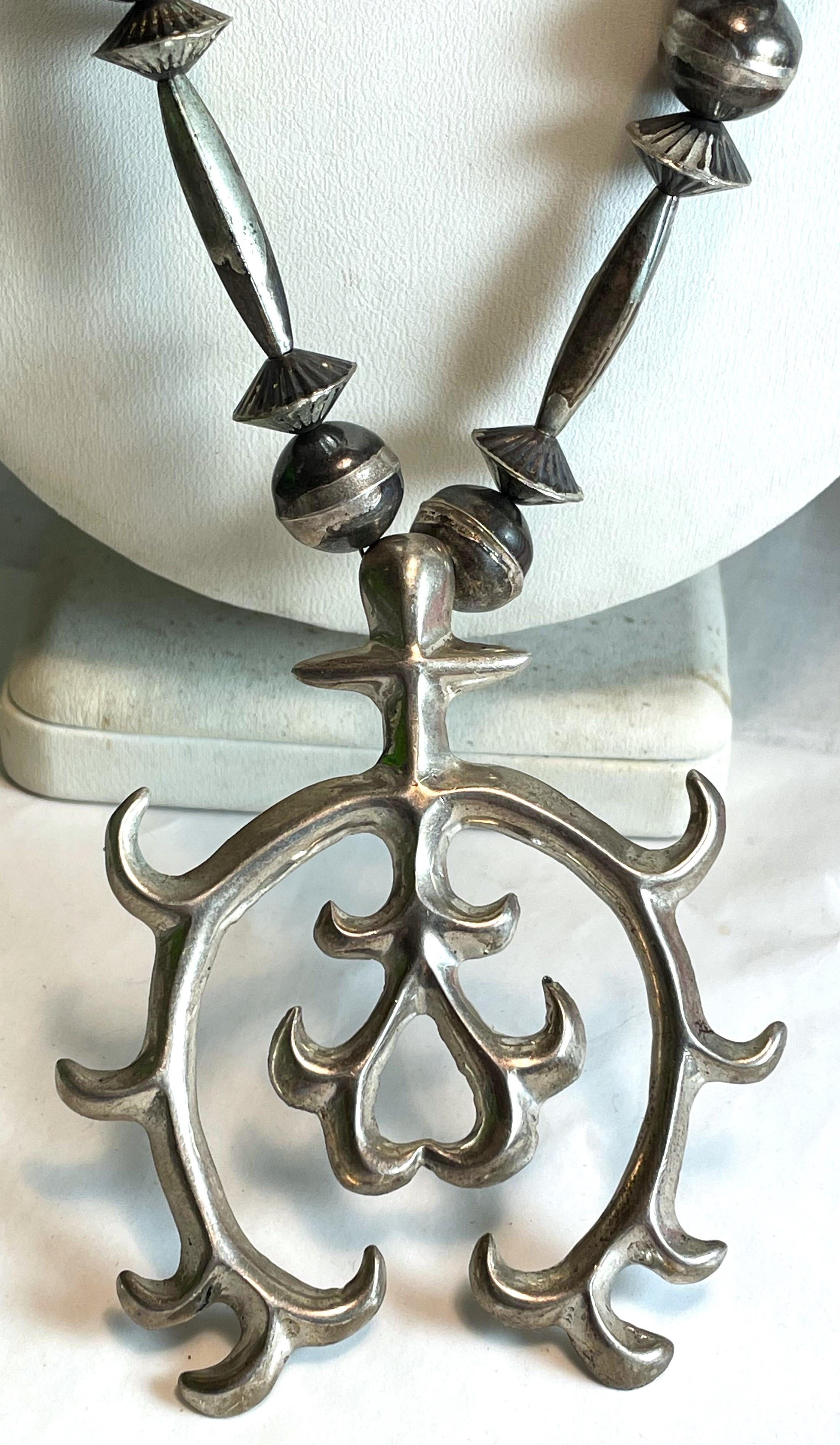 This is a fabulous large 3 inch by 2 1/2 inch sterling silver sandcast Naja pendant or enhancer which is currently hung on a 25 inch long bench made sterling silver bead necklace. 

The beads are safely strung on a silver chain with a bench made