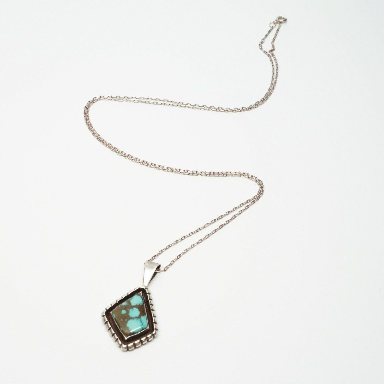 Navajo Native American Pendant Necklace by Eugene Belone

Stone rich with dark greens and turquoise colors.

Marked: Sterling Signed: EB

Measurements: 24