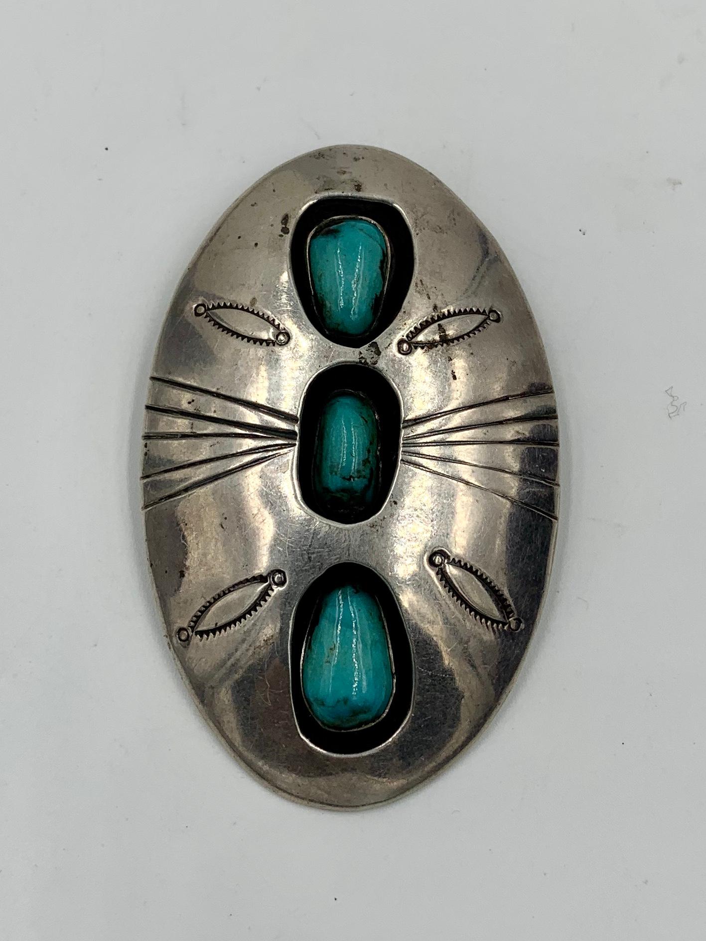 A stunning antique Native American Navajo Turquoise Shadowbox Pendant with beautiful hand stamped designs in Sterling Silver.  The pendant is a wonderful large size of 2 3/4 inches tall and 1 3/4 inches wide.  The three Turquoise stones are