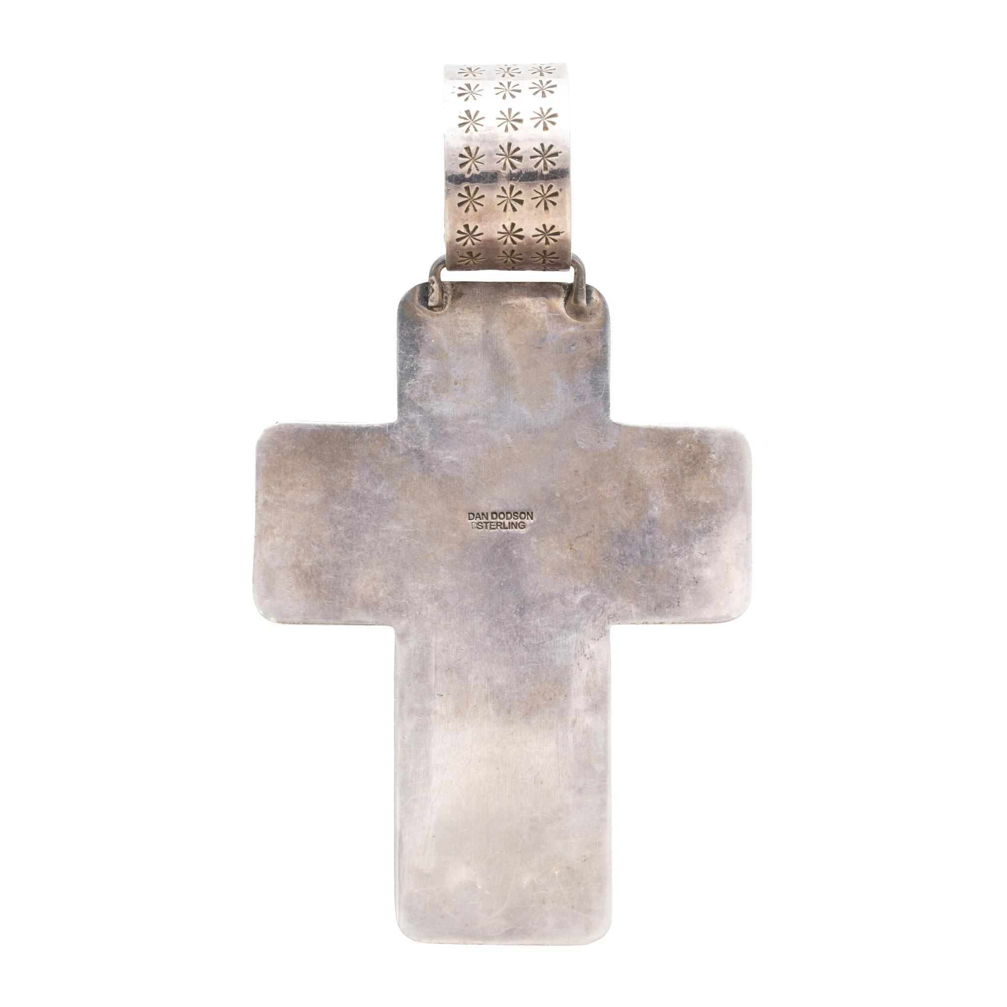 Navajo onyx and sterling silver cross pendant. Made by Navajo silversmith Dan Dodson by Santa Fe, New Mexico. Large sterling silver cross cut-out with hand-stamped details and sterling silver bead accents. Raised cross-shape stone of onyx in smooth