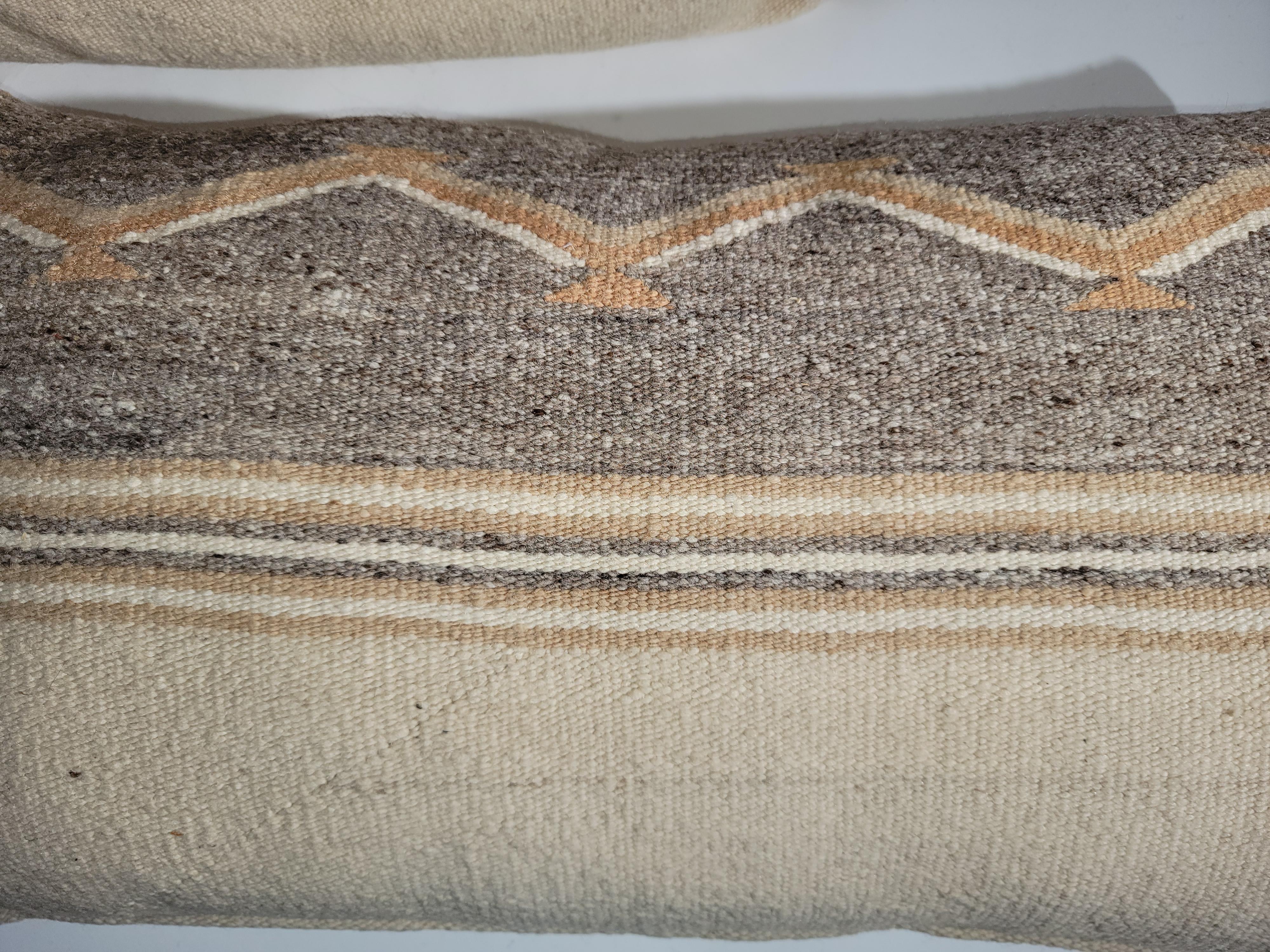 Pair of Navajo Bolster pillows in an beautiful natural color. great fitting in many settings. Great Adirondack feel. wonderful browns stripes with delectable mountain lines. Linen backing and down and feather inserts.