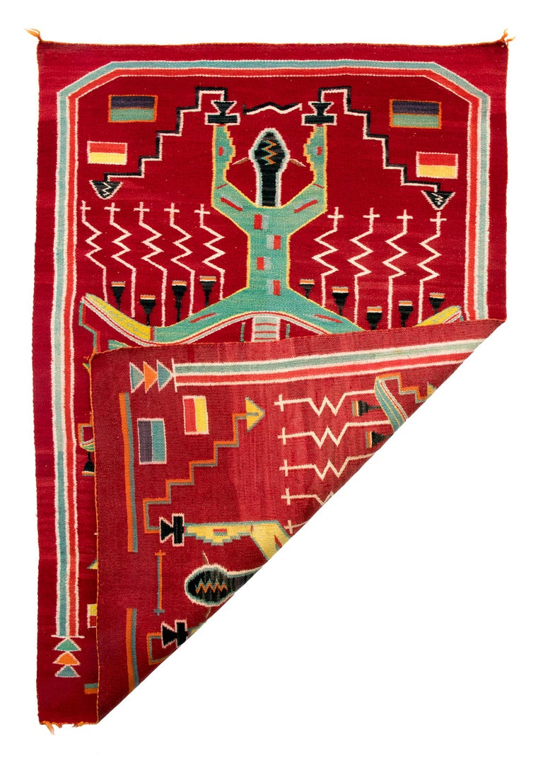 Vintage Navajo Pictorial weaving, vintage circa 1950 depicting two head to head Navajo Thunder Gods in yellow black and green against a deep red field. Hand-woven of native hand spun wool with aniline dyed red, green, yellow, black brown, and