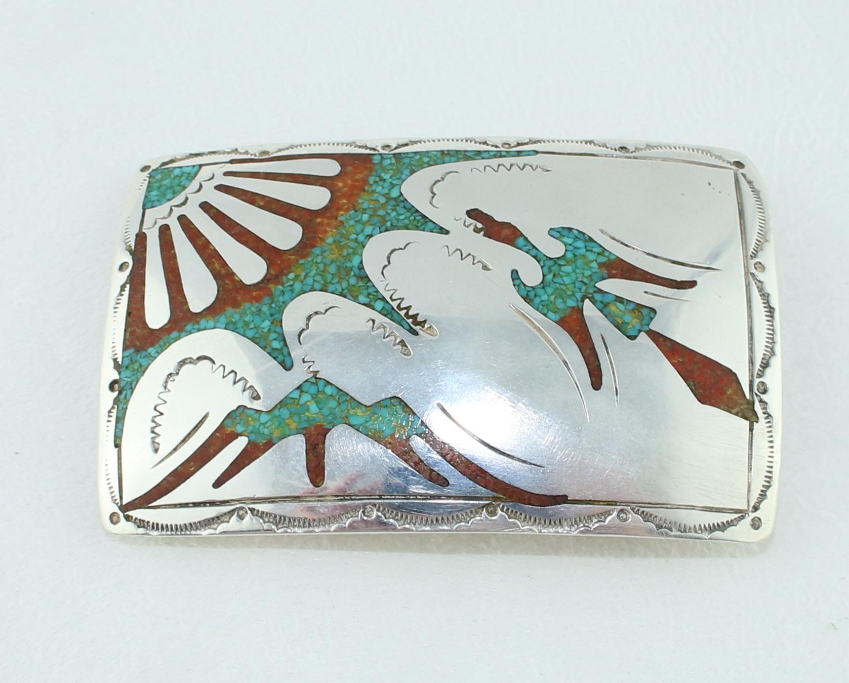 Stunning Navajo Peublo Scene by Frank Bowman
The scene depicts of Sun & Mountain and Peyote Bird In flight
The belt buckle has turquoise and coral chip inlay and is sterling silver
There is a makers mark on the back.
The buckle measures 2.75