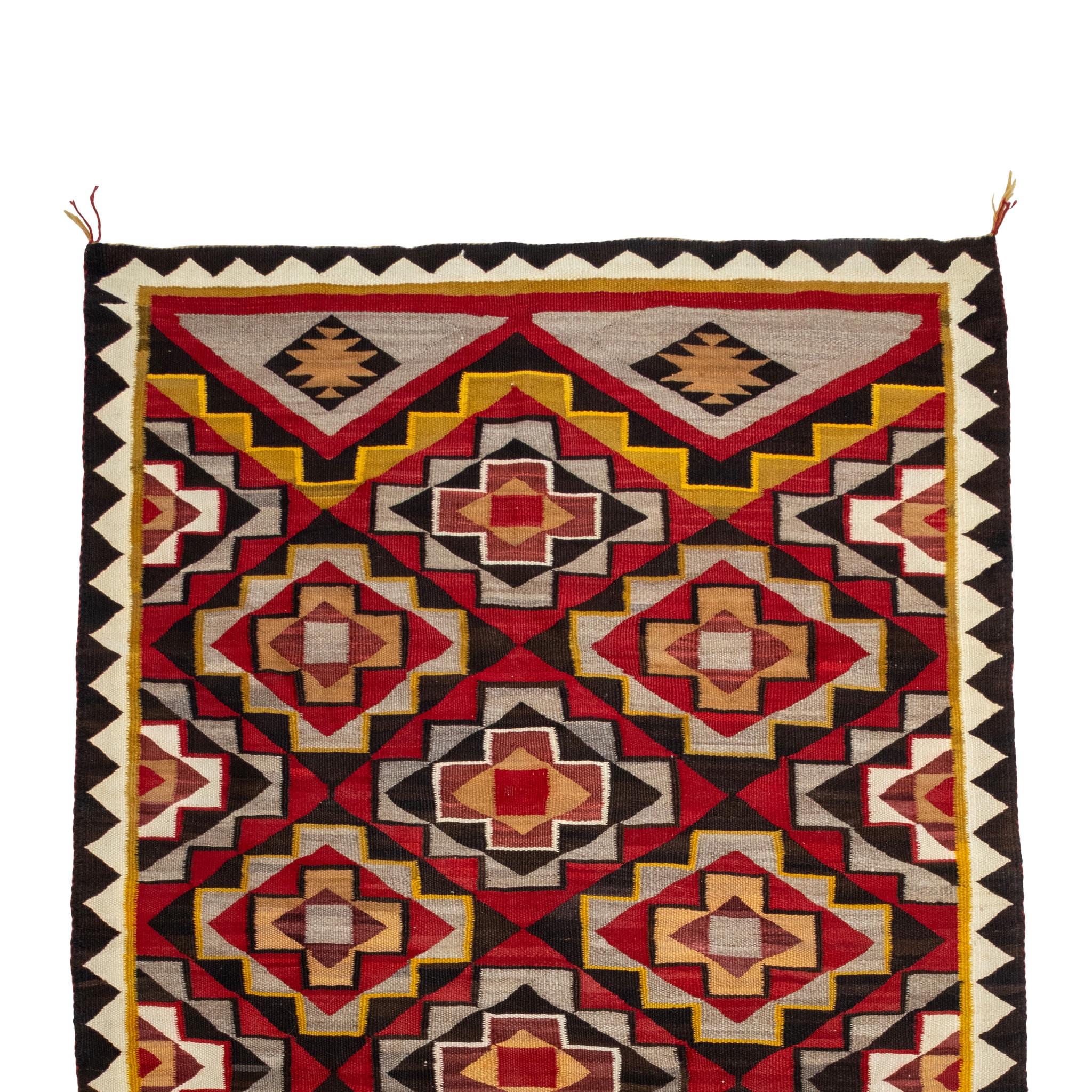 Navajo Red Mese wool weaving. Exceptional bright colors in tones of red, orange, blue, yellow, grey and cream. Having repeating geometric crystal patterns with serrated border. Bright and graphic, a beautiful addition to any handmade indigenous