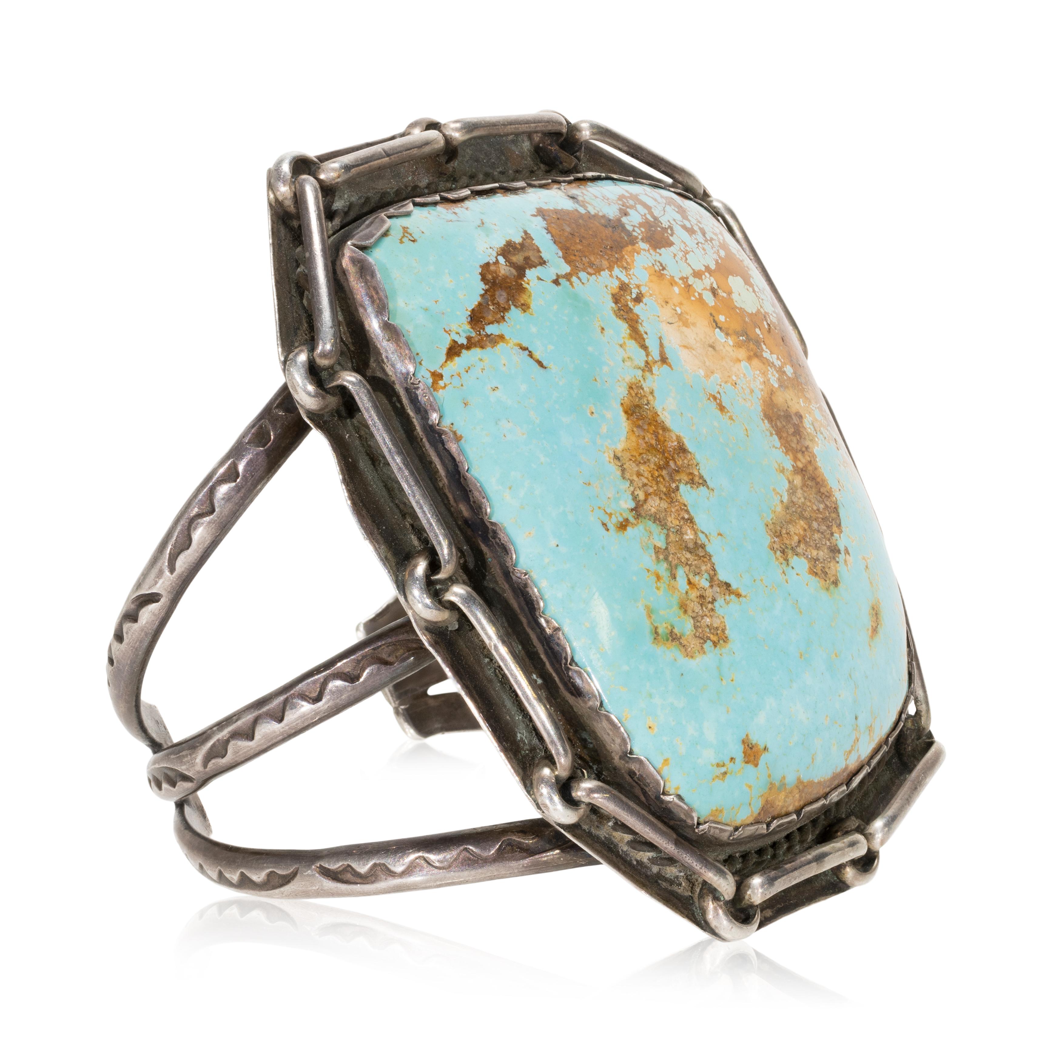 Large Navajo Royston turquoise and sterling silver bracelet. Large beautiful center stone surrounded by chain links in shadow box design with twisted rope border and three bands along sides with hand stamped detail. Heavy patina but can be buffed