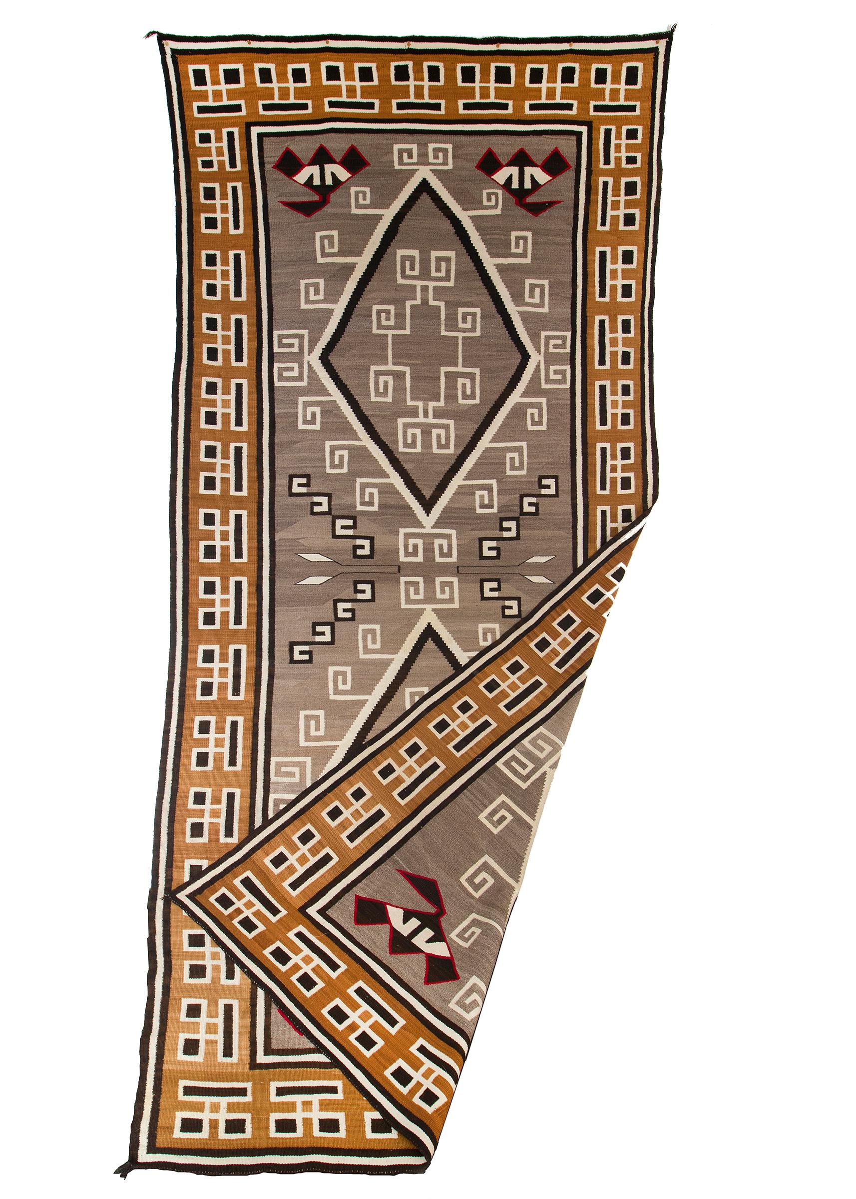 Vintage Navajo trading post rug, circa 1910-1920. Crystal Ganado design handwoven of native hand-spun wool in natural fleece colors with aniline dyed red. This large area rug is well suited for use on the floor or as a wall hanging.