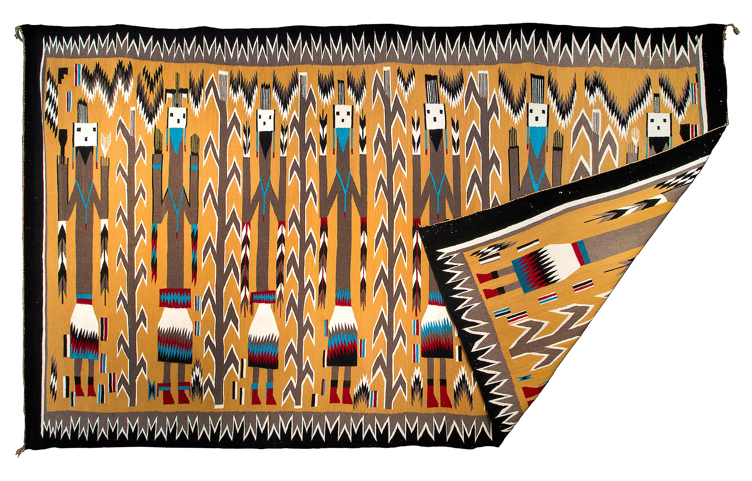 Vintage Navajo area rug, circa 1950s, Pictorial Weaving with seven Yei (Yeibichai) figures holding feathers. Hand-woven by a Navajo weaver in colors of yellow, black, white, blue and red. This southwestern rug is well suited for use on the floor as