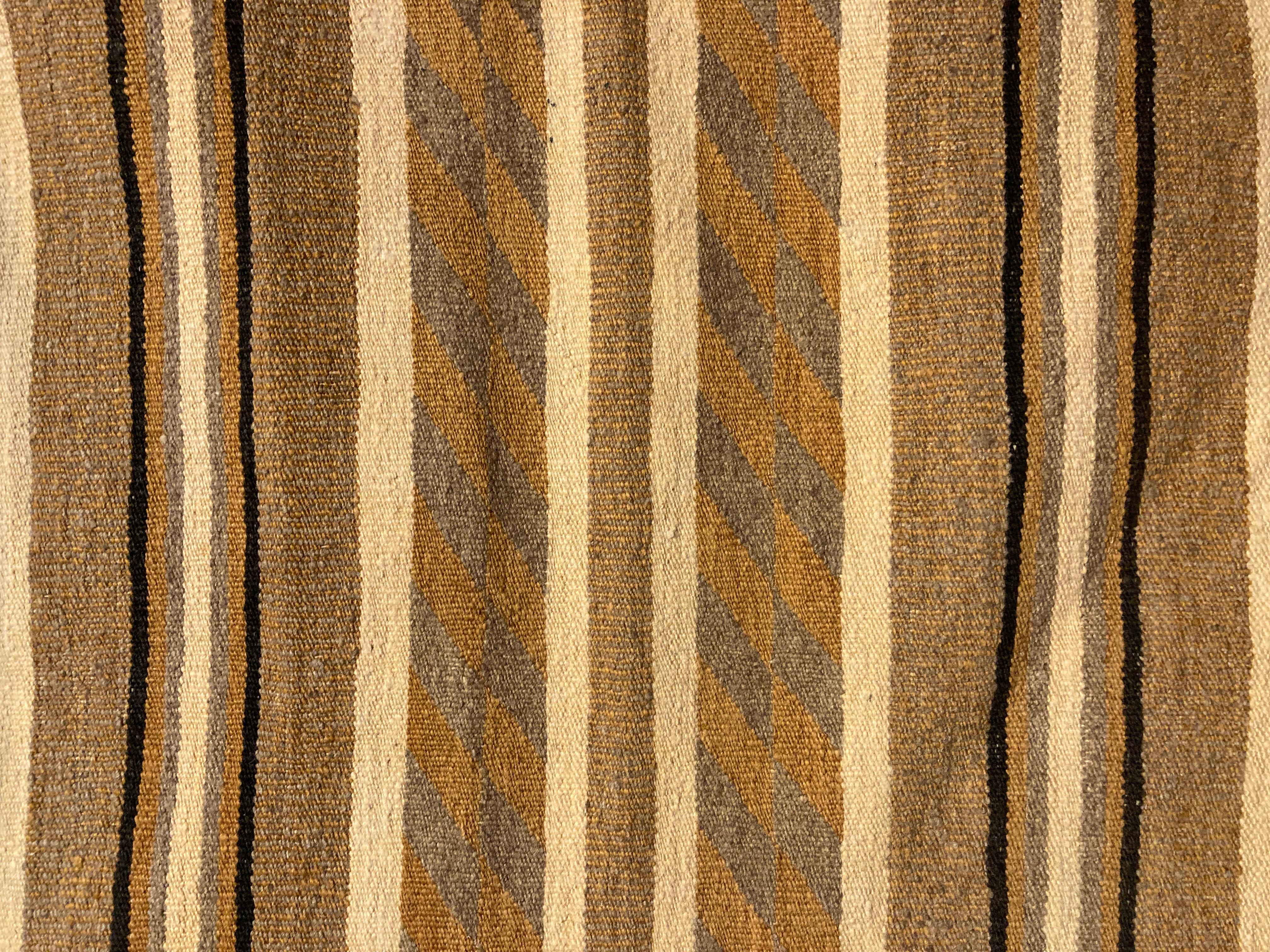 Unusual vintage Navajo rug, done in ivory, gold, un-dyed grey and dark brown wool, has a serene, contemporary look.