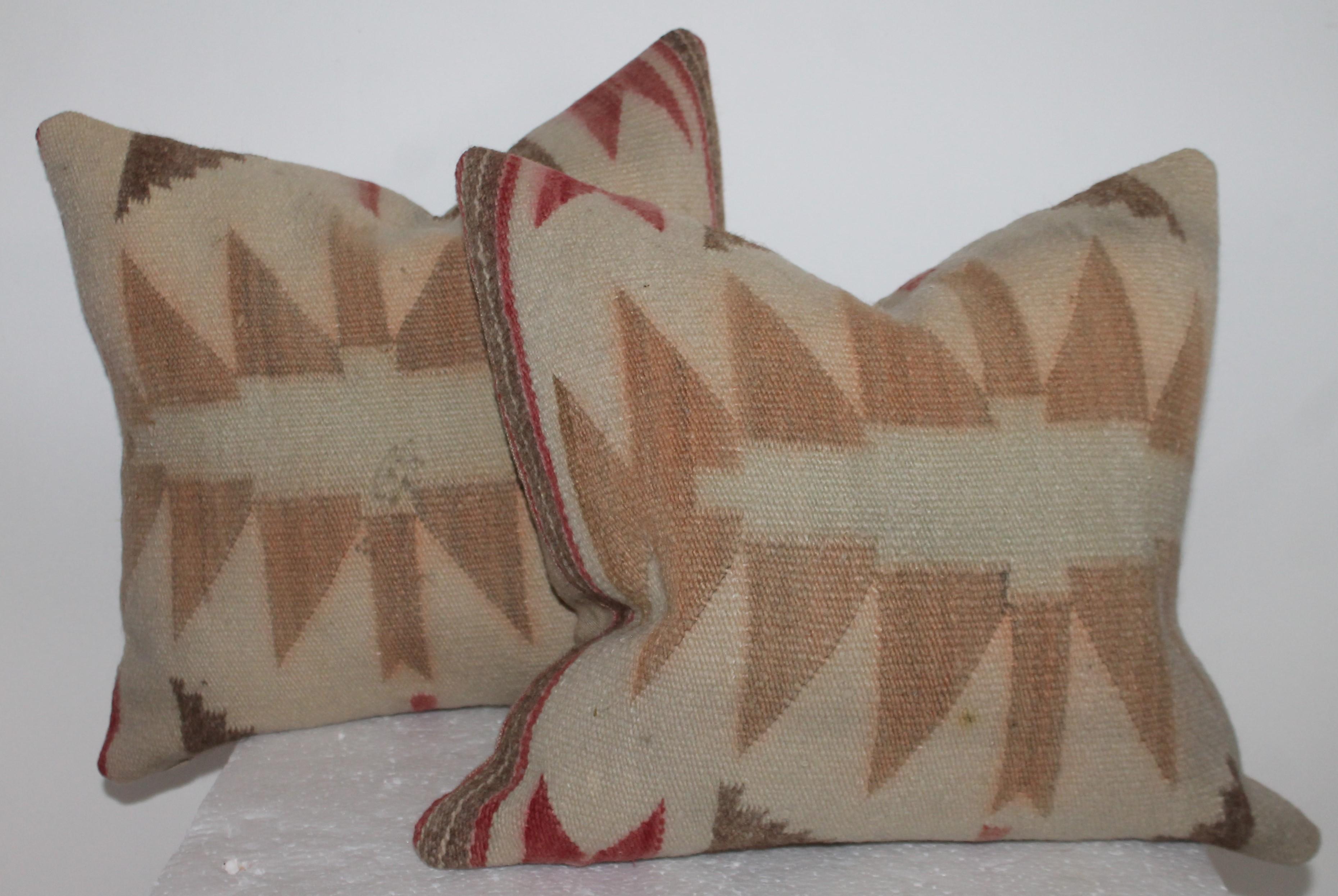 Faded Navajo weaving saddle blanket pillows with linen backings.