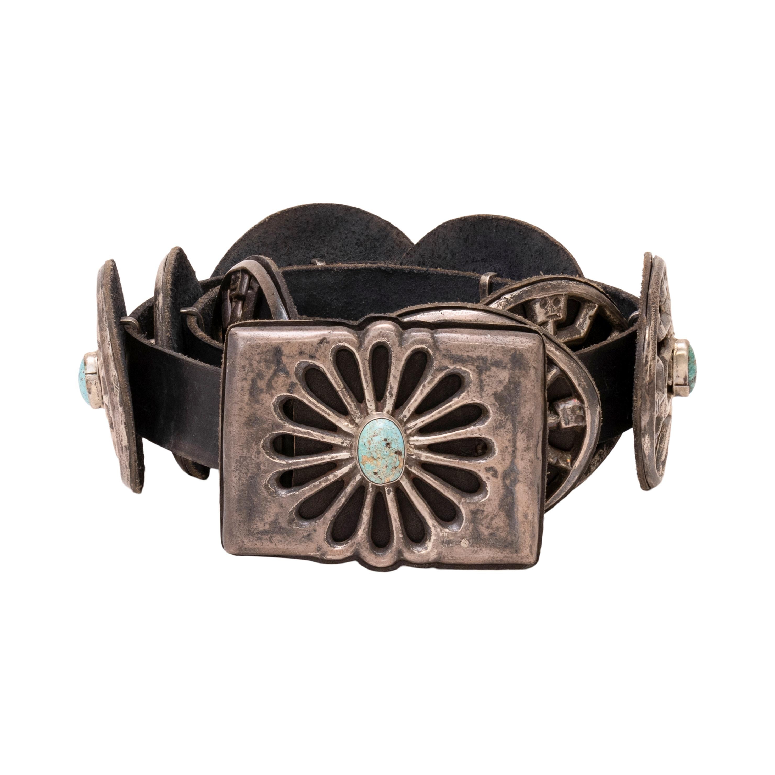 Navajo sand cast concho belt. Rectangular buckle with 8 oval conchos. The turquoise is from the Kings Manassa Mine in Nevada. Eight conchos total. Each concho leather backed with silver bar loops holding them onto soft leather belt. Old Pawn. From