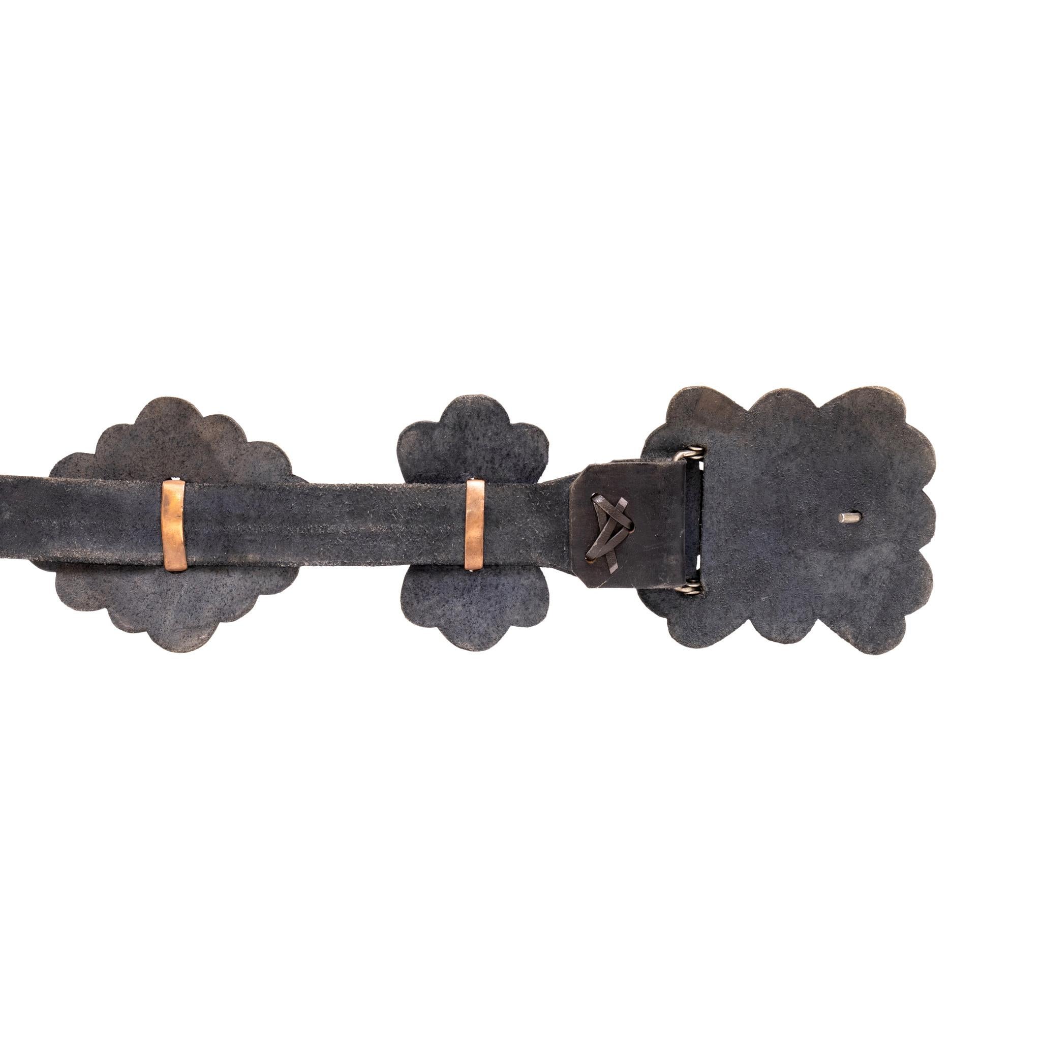 Navajo sandcast concho belt. With eleven total conchos plus buckle, each concho backed with leather. The turquoise is from the Morenci Mine in Arizona. Each stone surrounded by twisted rope border with stamped sterling bead accents. With copper