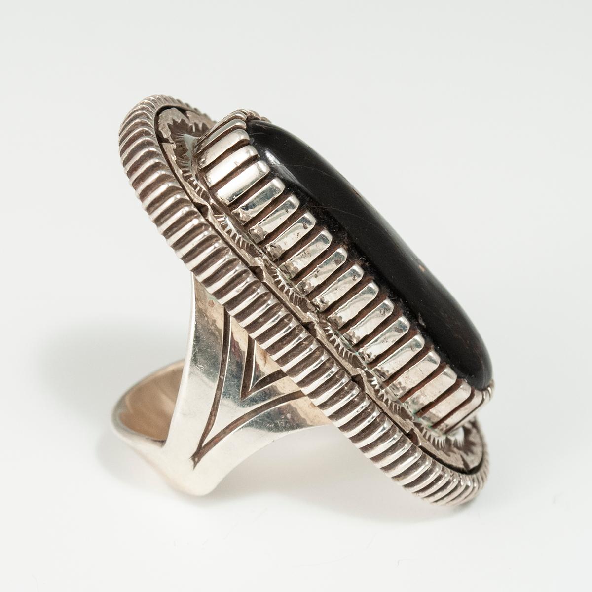 20th century black coral and silver ring by Navajo Silversmith Mitchell Toney 

A contemporary black coral and sterling silver ring by Navajo silversmith Mitchell Toney. Size 7.5, weight 26 grams.
Measures: H 1.75 x W 1 x D 0.38 inches.

