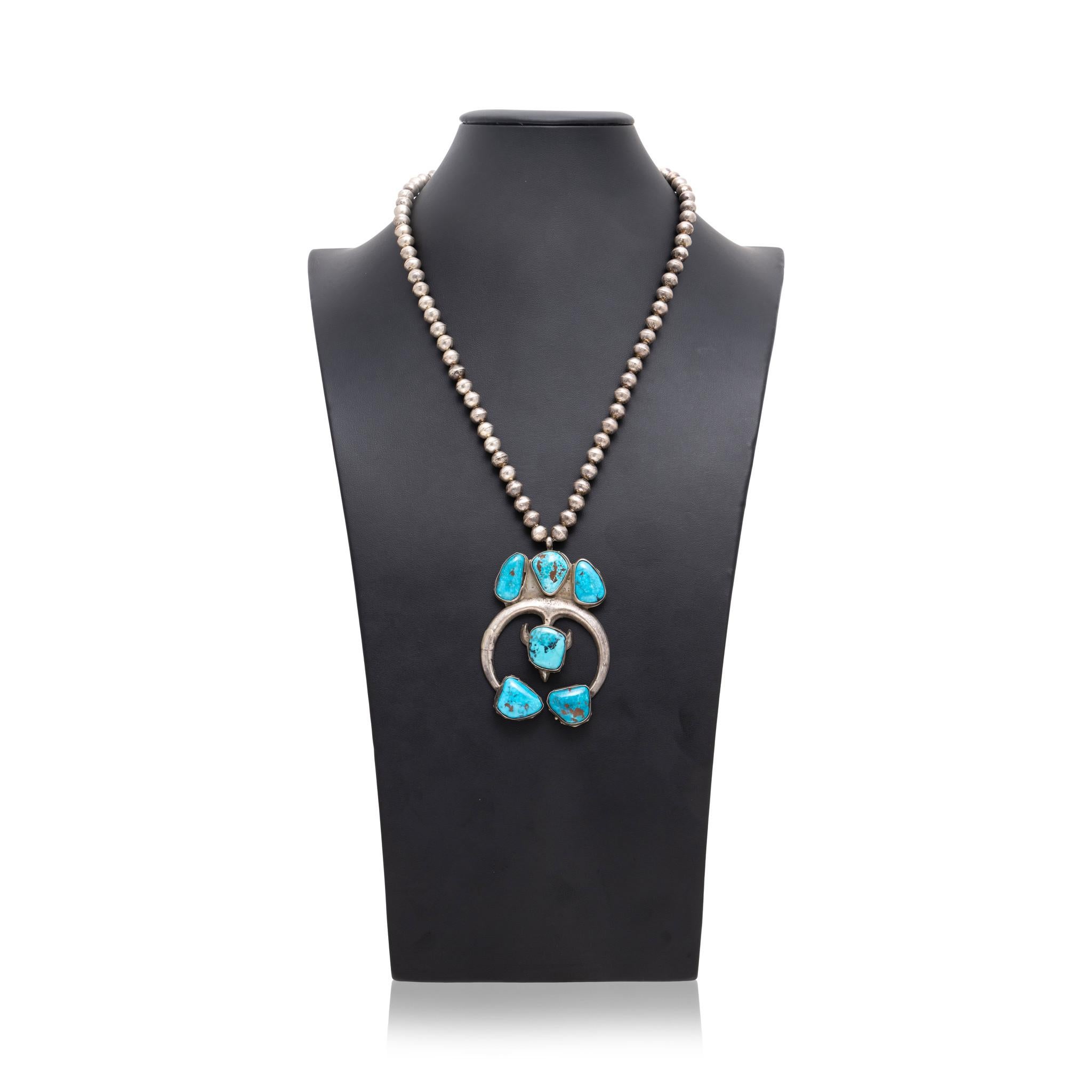 Native American Navajo Indian turquoise and sterling silver sand cast necklace. Six Morenci turquoise stones attached to a sand casted naja style pendant on Navajo pearl chain. No maker's mark. Stones are a vibrant and bright blue color with minimal