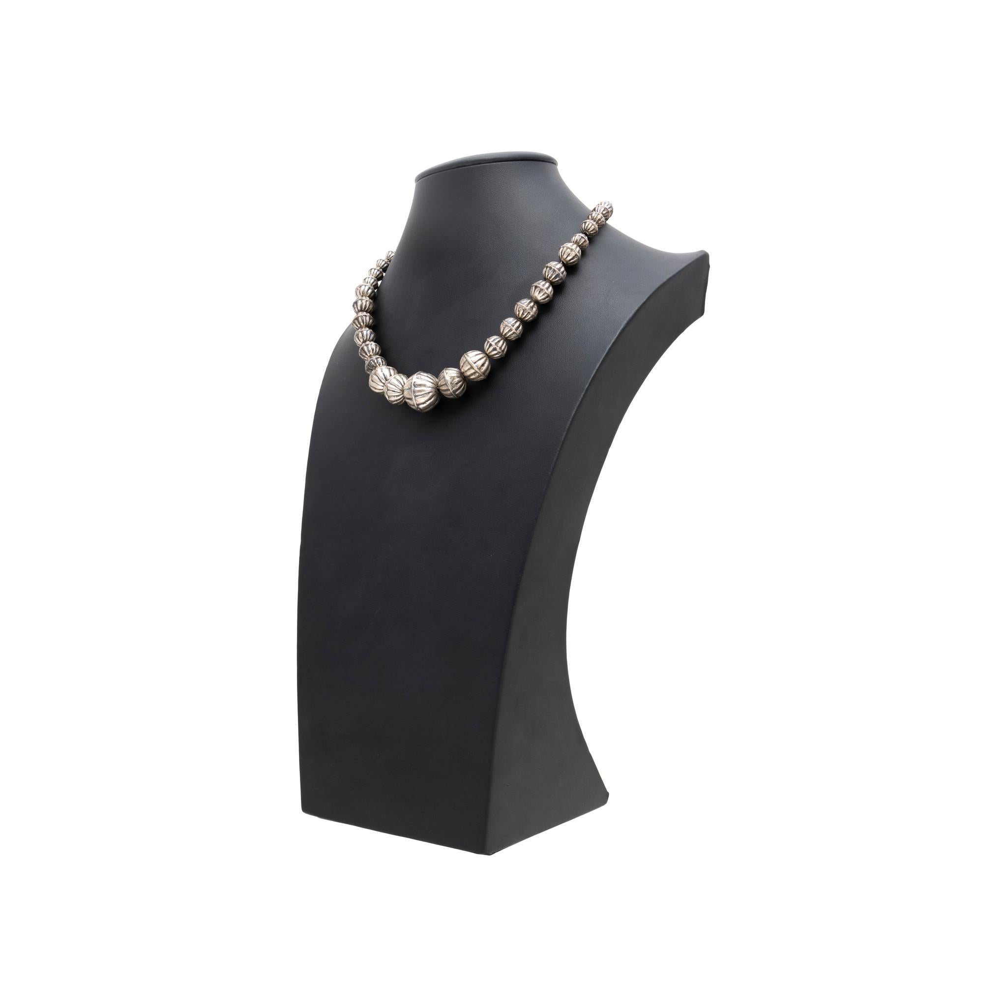 Sterling silver Navajo pearl necklace. Graduated pearls with hand stamped line design and traditional clasp. No maker's mark. Old Pawn. From the Indian Store in Clovis, New Mexico. Great for solo wearing or layering with other pieces. 20th century.