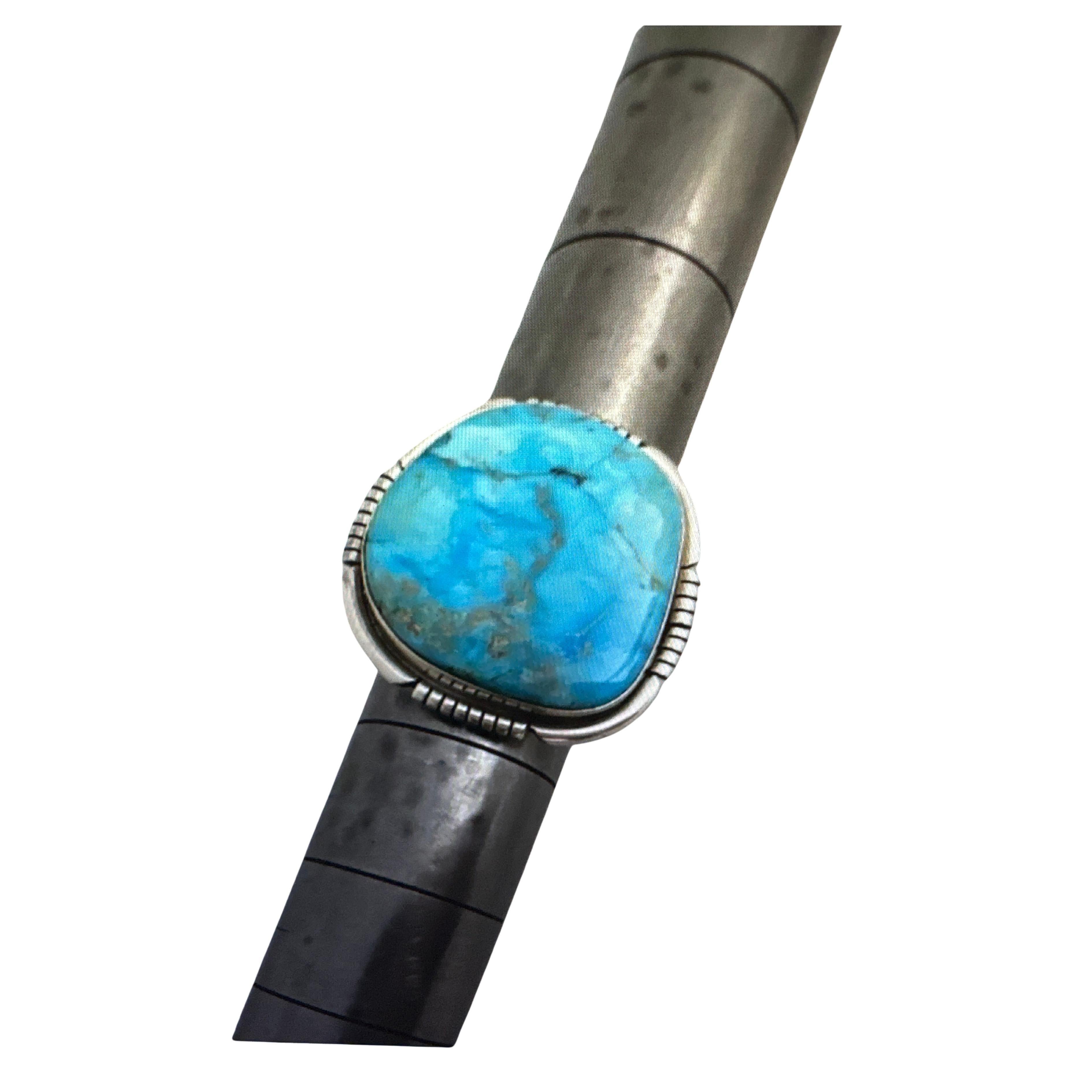 Navajo artist Dave Skeets Sterling Silver .925 Sleeping Beauty Turquiose 27mm x 29mm freeform Ring Size 7

Stone measures approx 23mm x 25mm
High luster polish ... beautiful Stone !!!

Turquoise, a blend of the color blue and the color green, has