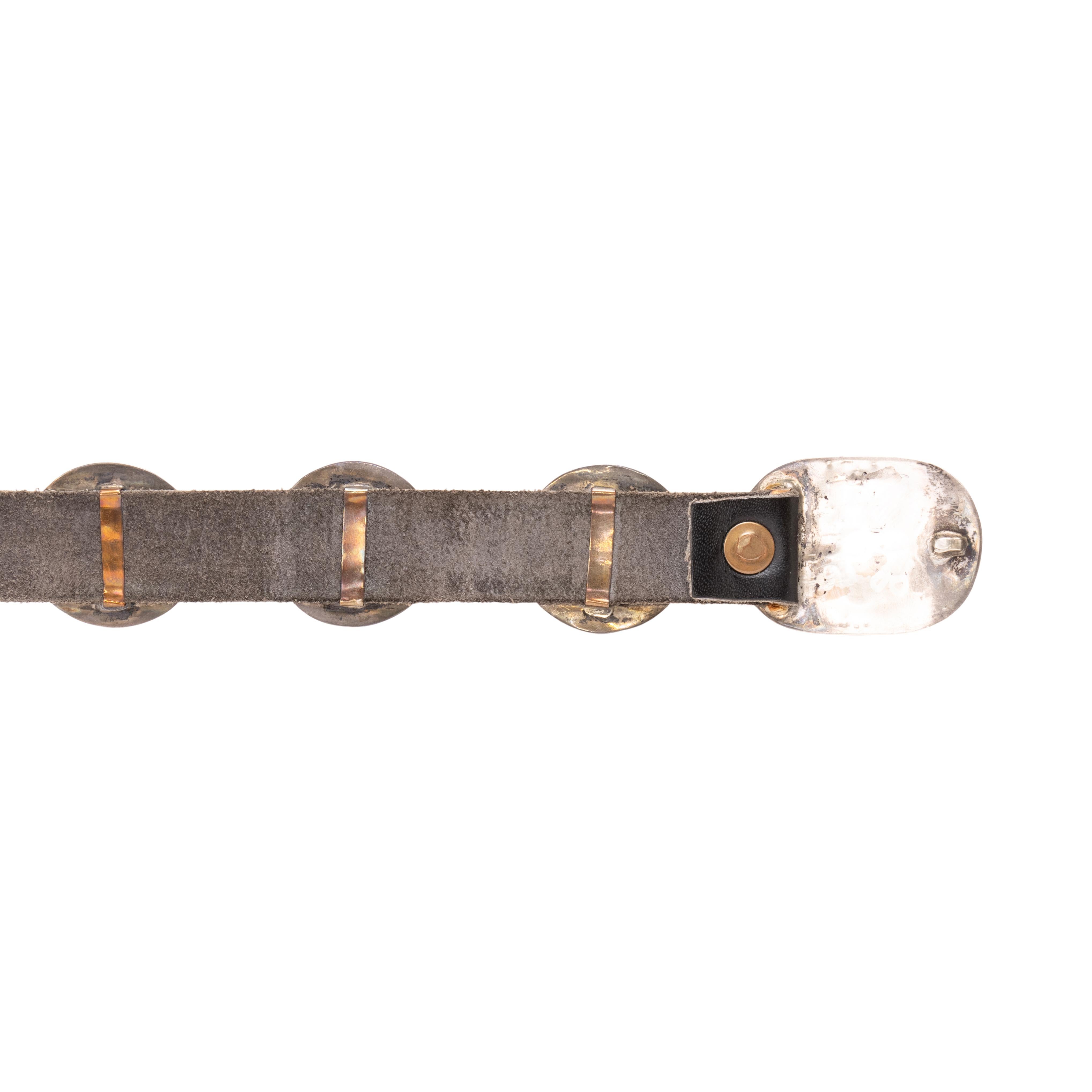 Navajo sterling silver concho belt. Fourteen round conchos with matching oval belt buckle. Each concho having shadowbox sterling silver design with cluster of eight Sleeping Beauty turquoise stones surrounding single red coral nugget in center.