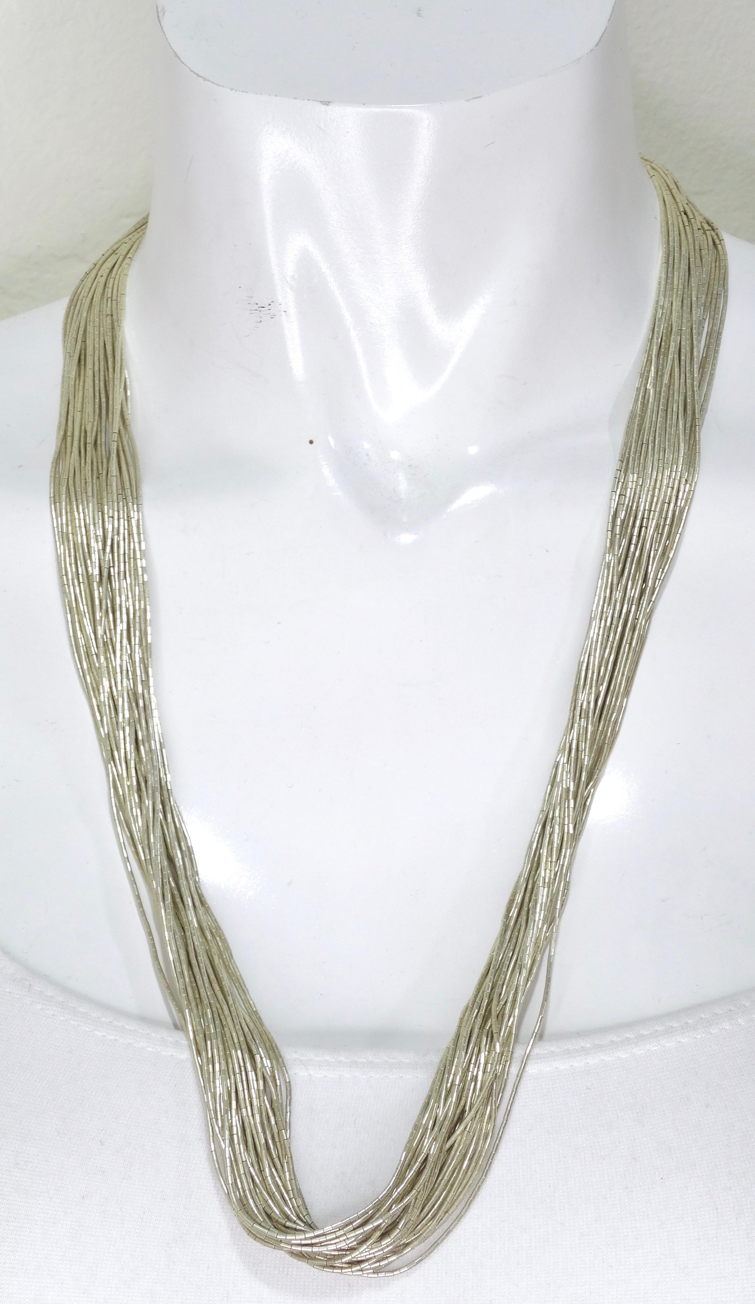 Here is another treasure to add to your jewelry trunk! An extremely unique Navajo vintage liquid silver necklace with a rare count of 30 strands. The 30 strands are made of hundreds of beads strung together to create a cascading liquid look that is