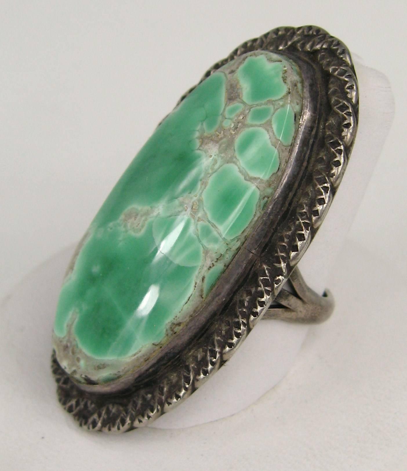 Stunning hand crafted Navajo Turquoise ring Measuring 1.82 in. x 1. in. Large bezel set turquoise Stone. The Ring is a 6.75in. and can be sized by your jeweler. This is out of a massive collection of Designer Clothing as well as Jewelry such as 