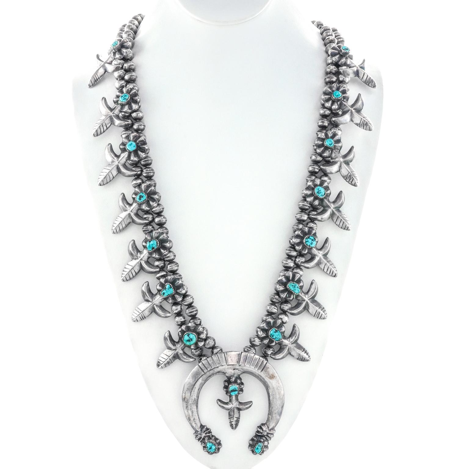 Circa 1970s, Sterling, by Nellie Tso, Navajo.   A marvelous example of Navajo silver smithing, this large turquoise-set squash blossom necklace has it all -- color, quality, and size. Made by Nellie Tso, the look is iconic Western Americana at its