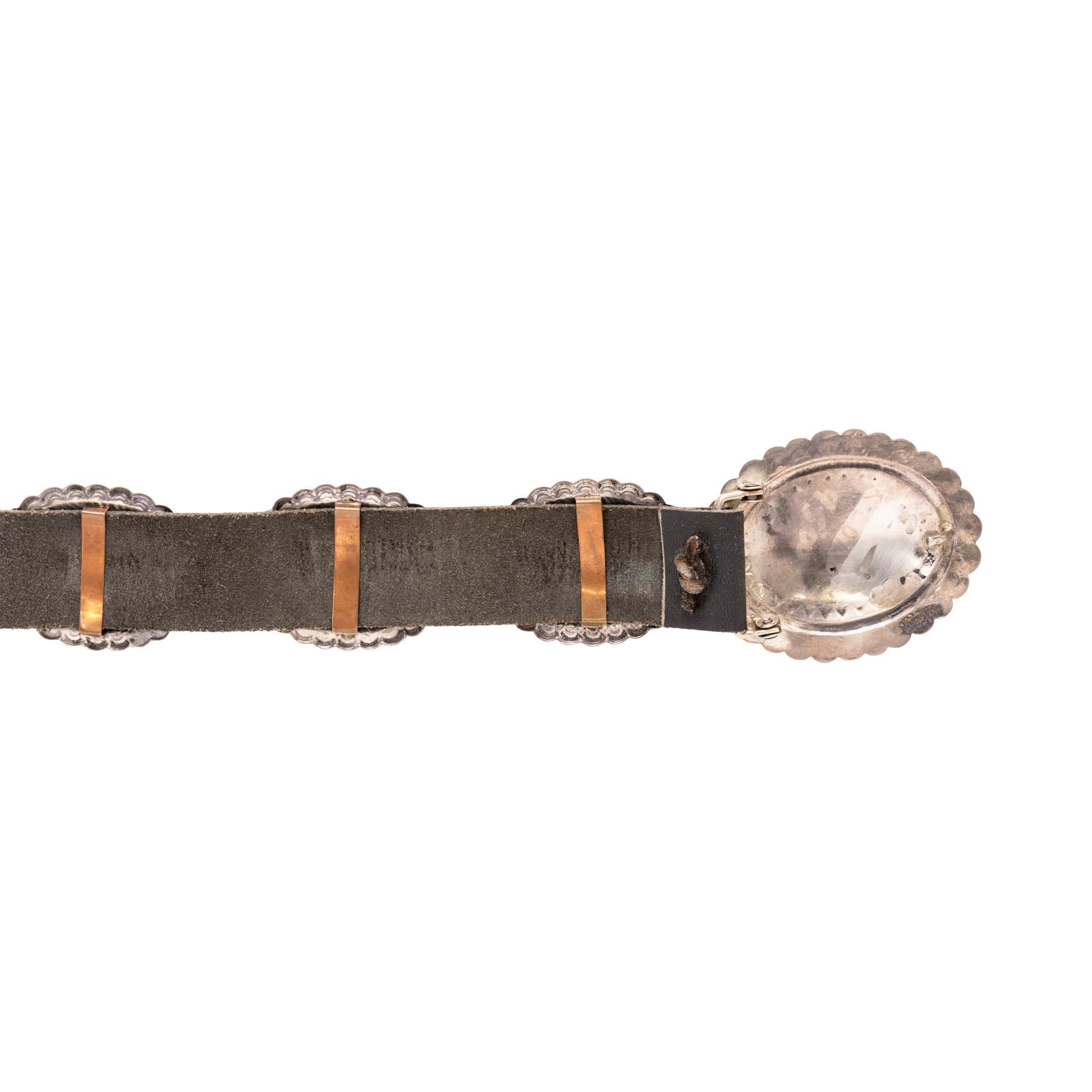 Navajo stylized silver concho belt. Seventeen oval conchos with matching larger buckle. Each concho without any stones, having undecorated sterling silver with stamped borders and scalloped edges.  Beautiful classic design with great patina from age