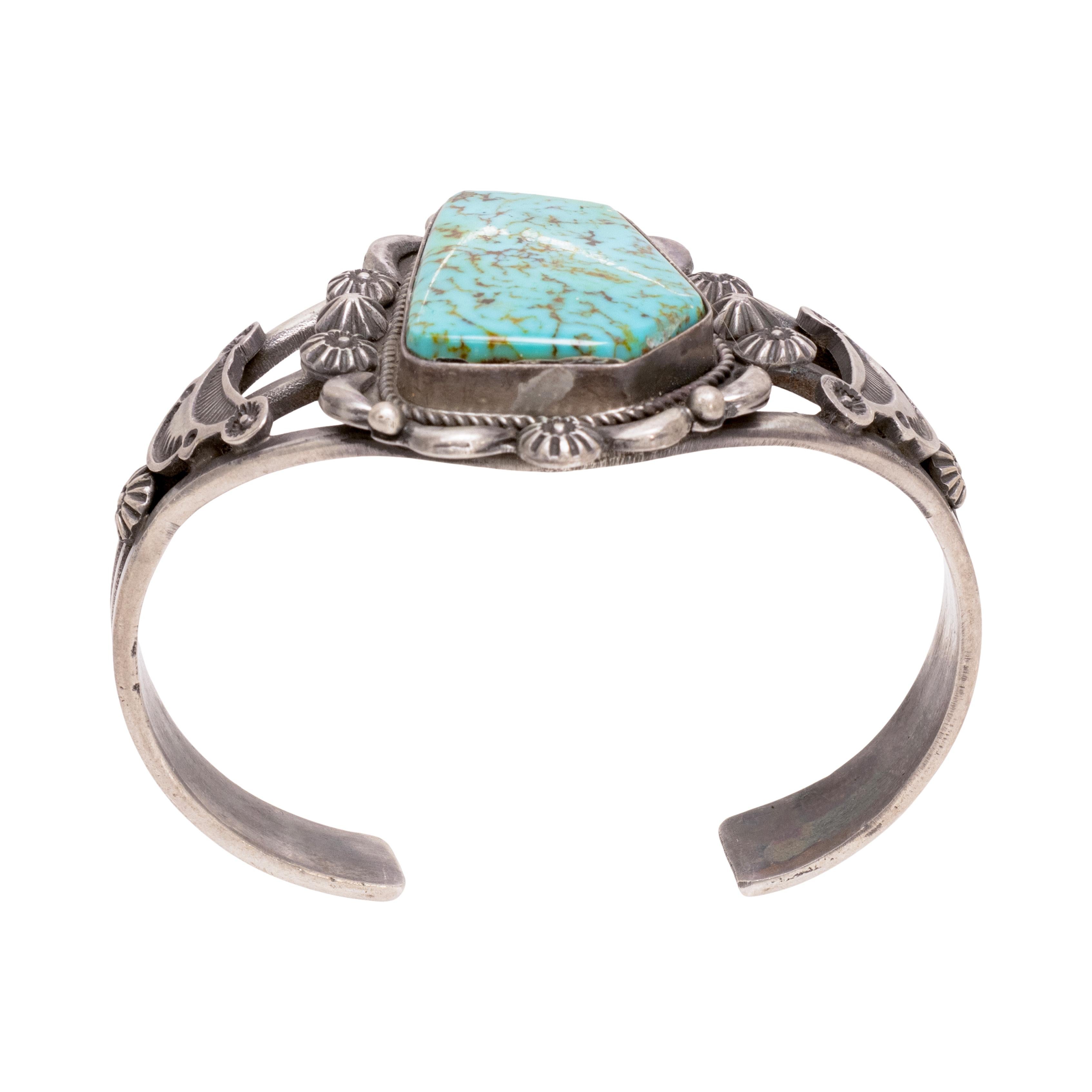 Navajo single stone turquoise bracelet with stars. Beautiful large stone with hand stamped stars and detail with twisted rope borders. Hand stamped sterling details flows on sides on bracelet. Marked 