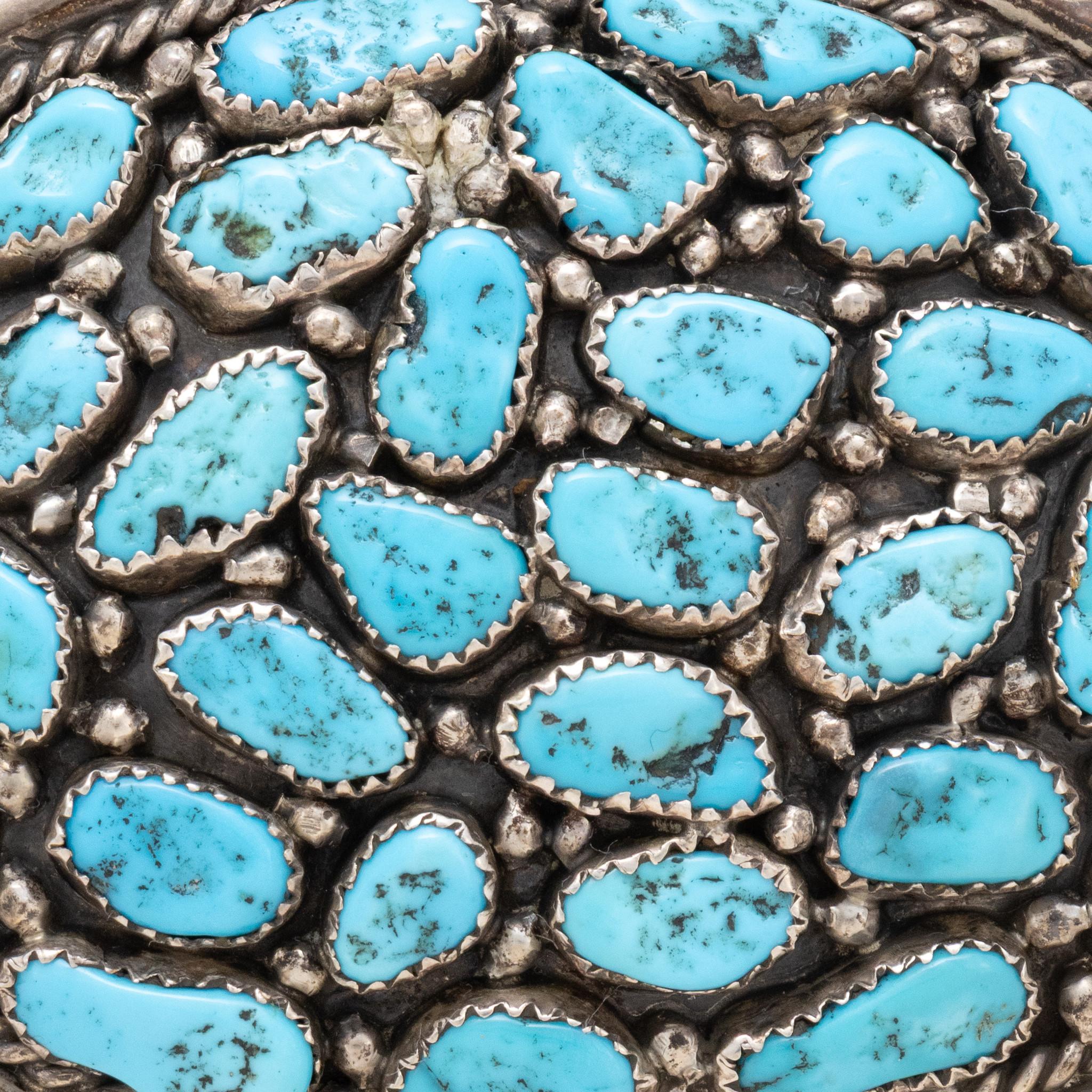 Navajo sterling silver and Kingman turquoise nugget buckle. Multiple natural, untreated stones with Grade A quality turquoise. Each stone in sawtooth bezel setting, set in semi shadowbox with sterling silver bead accents. Framed by twisted rope and