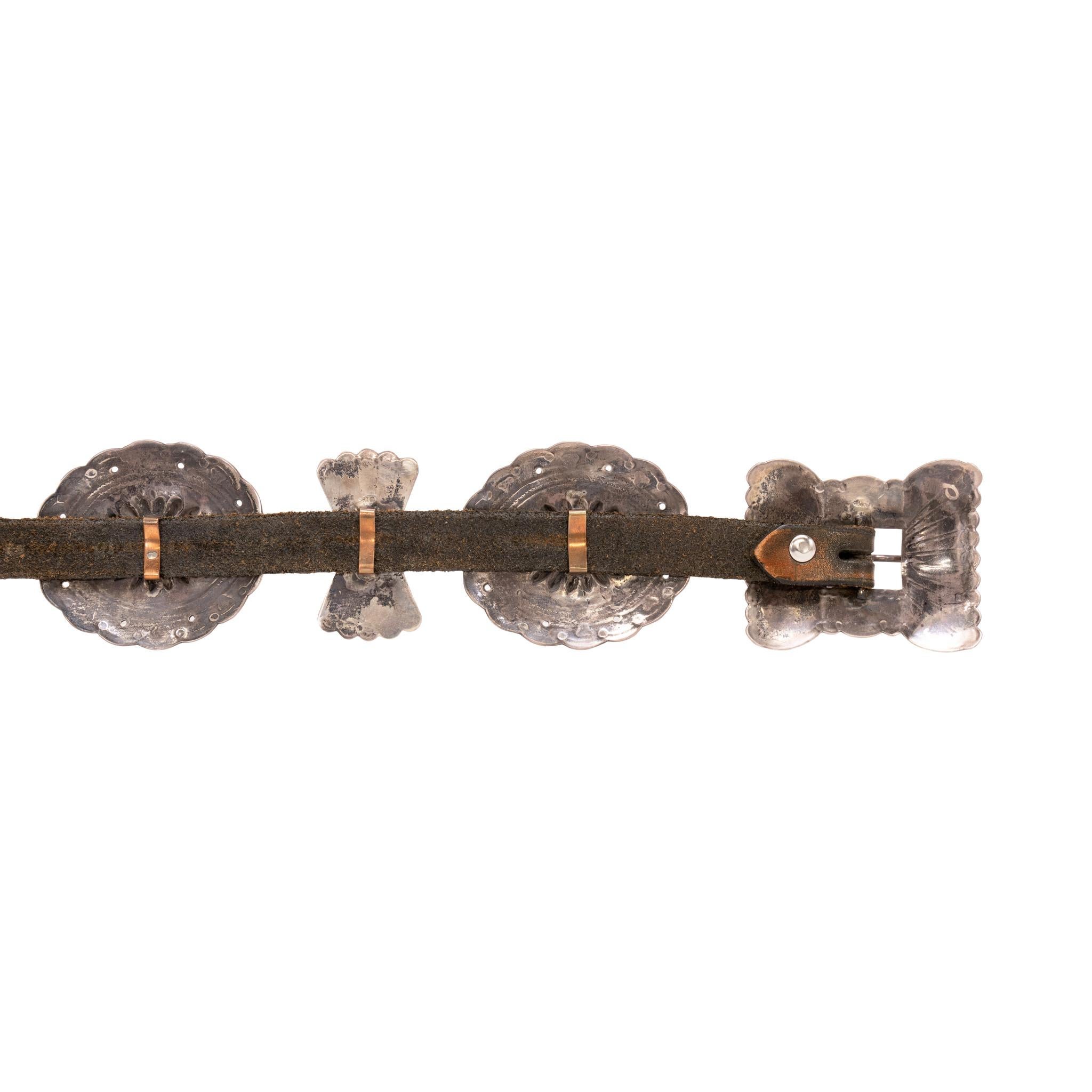 Navajo turquoise and sterling silver concho belt. Eleven total conchos having oval and butterfly shapes with rectangle buckle. Oval conchos have single stone of Royston turquoise, with four matching stones on buckle. Stones are a light green with