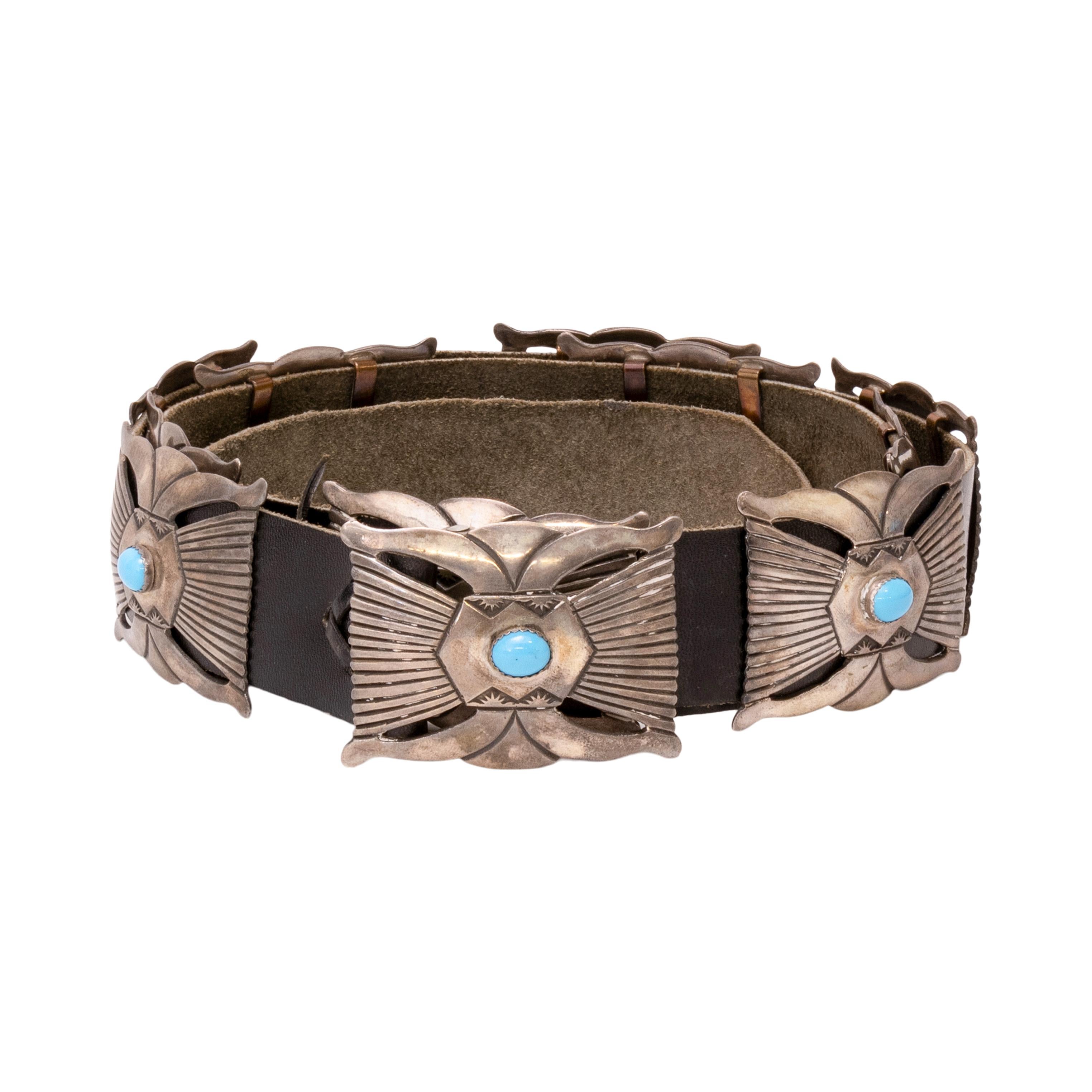 Navajo turquoise and sterling silver concho belt. Eleven rectangle conchos with single Sleeping Beauty turquoise stone in smooth bezel setting. Hand stamped designs on sterling conchos with open design at top and bottom. Each concho with copper