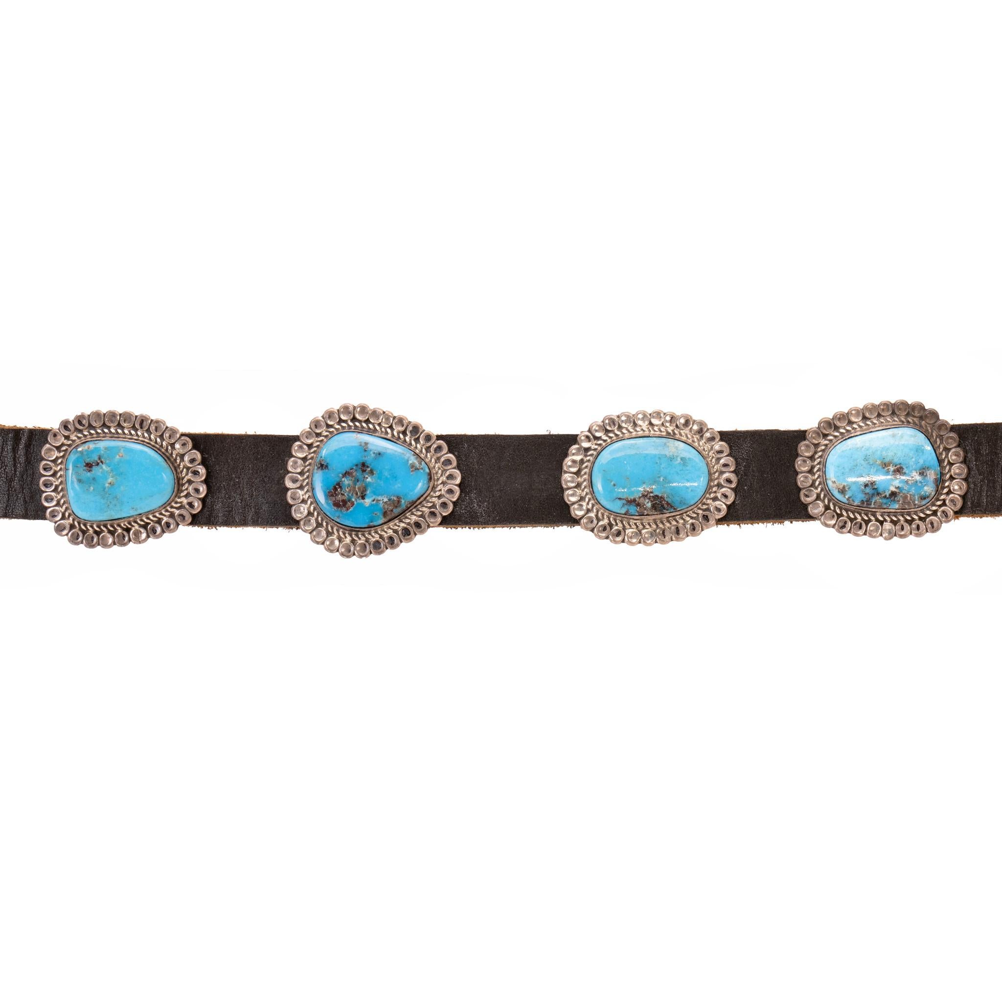 Navajo Bisbee turquoise and sterlingconcho belt. 18 stunning turquoise chunk conchos surrounded by twisted rope and stamped sterling bead border with mirrored design on larger belt buckle. Each stone in smooth bezel setting Attached to black leather