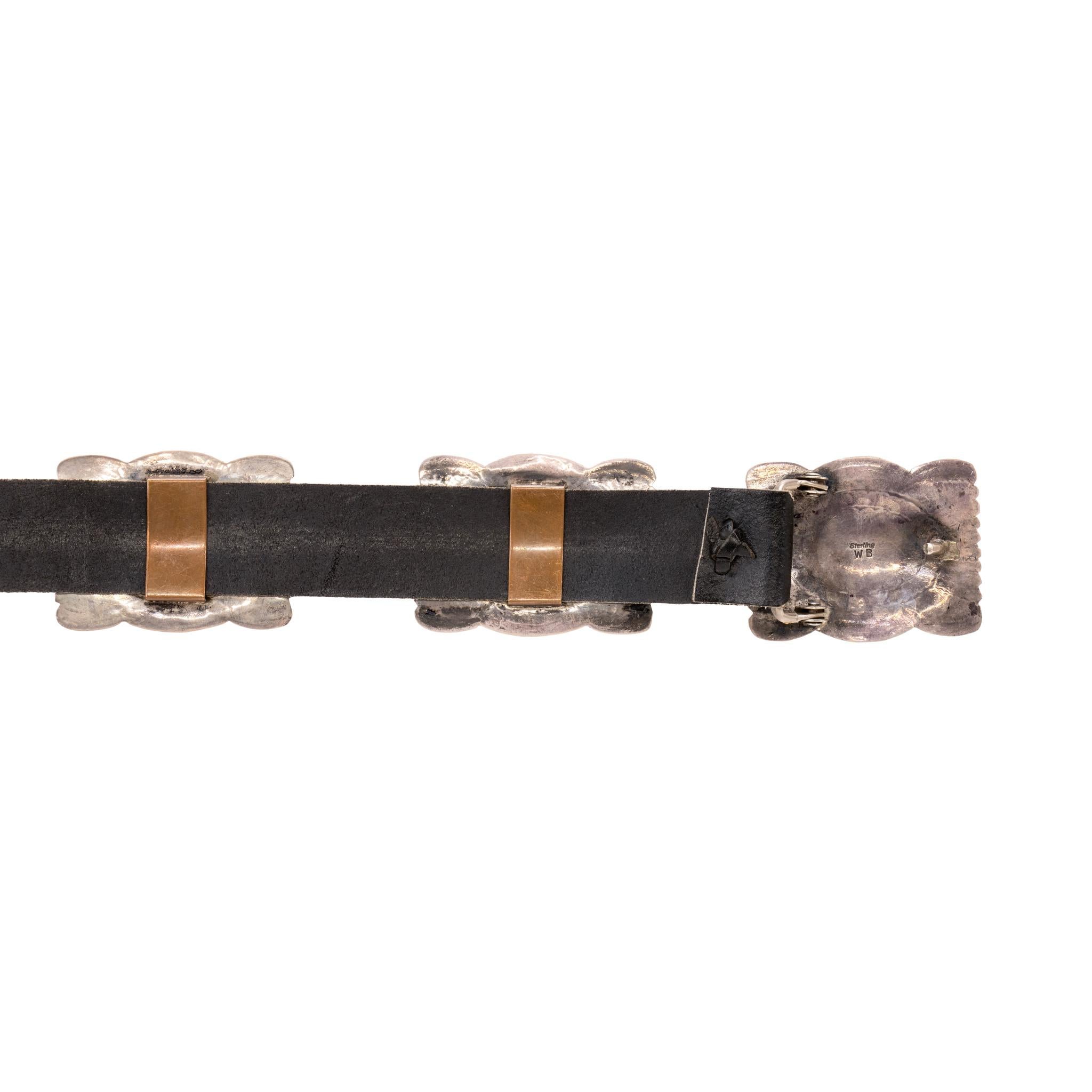 Navajo sterling silver turquoise and concho belt. Eleven total conchos with matching buckle, each a rectangle shape with scalloped tops. Stamped designs surrounding center small Sleeping Beauty turquoise stones in sawtooth bezel setting. Each concho
