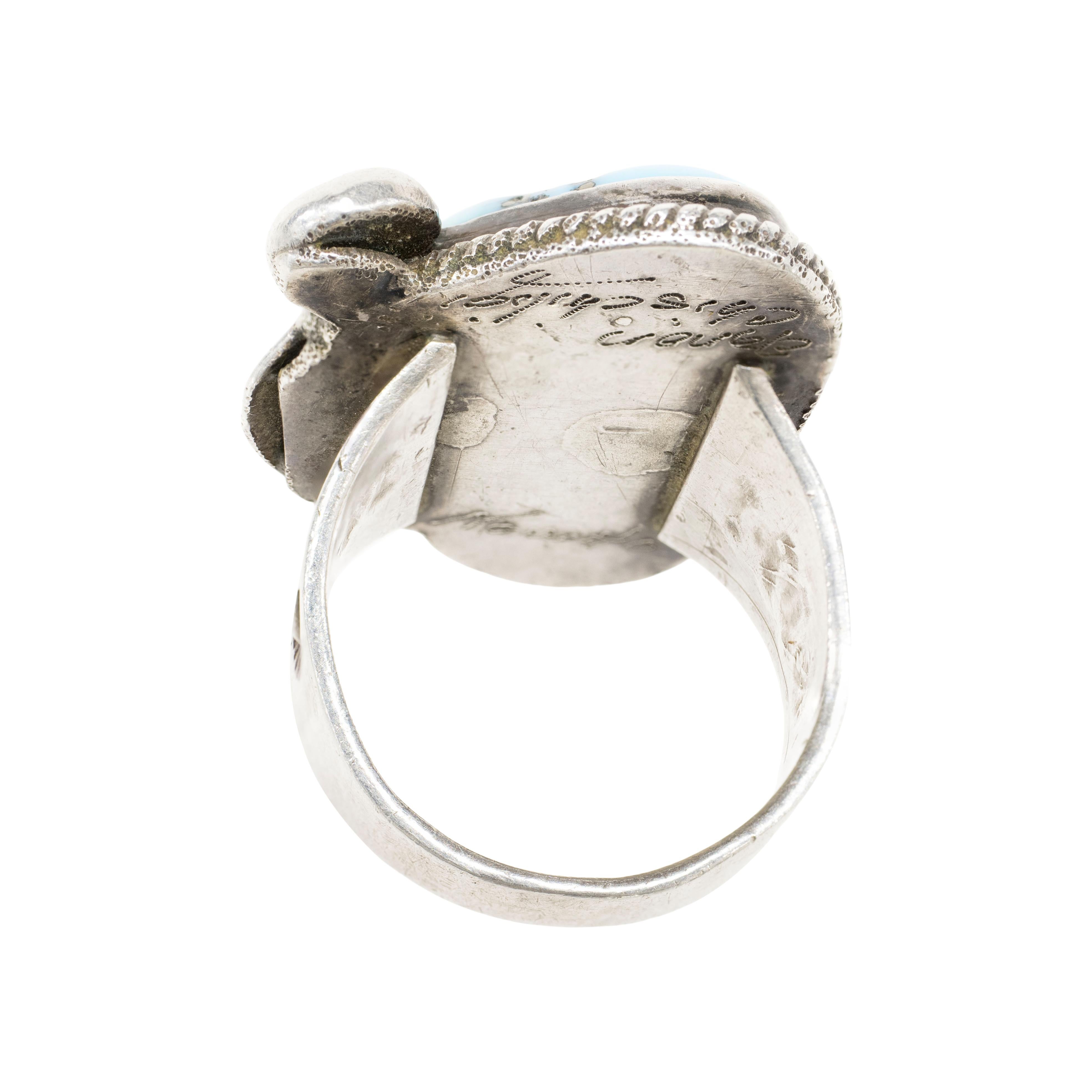 Navajo sterling silver and Carlin Turquoise ring. Large, natural, untreated stone stet in sterling silver shadowbox with feather and bead detail. Stone is a beautiful light blue with silver and black matrix. Engraved by the maker 