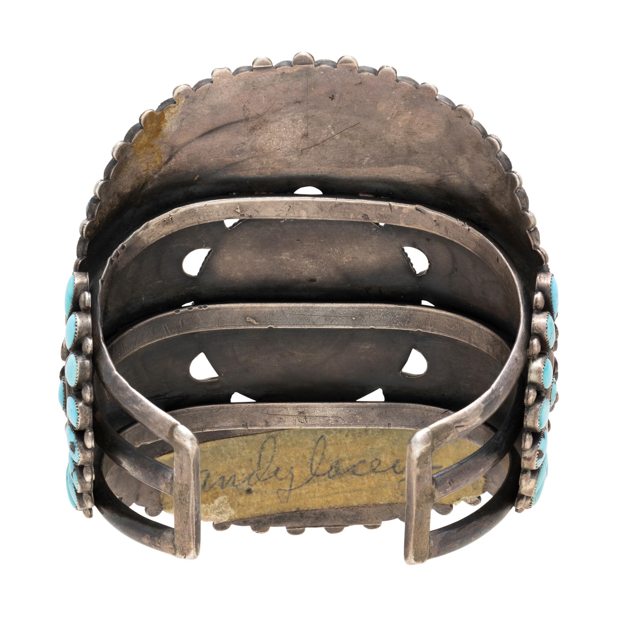 Navajo petit point turquoise and sterling cluster bracelet. Great older piece with nice patina and sturdy quality Sleeping Beauty turquoise stones set in an impressive display with 125 stones. Accented with scalloped sterling filigree and twisted