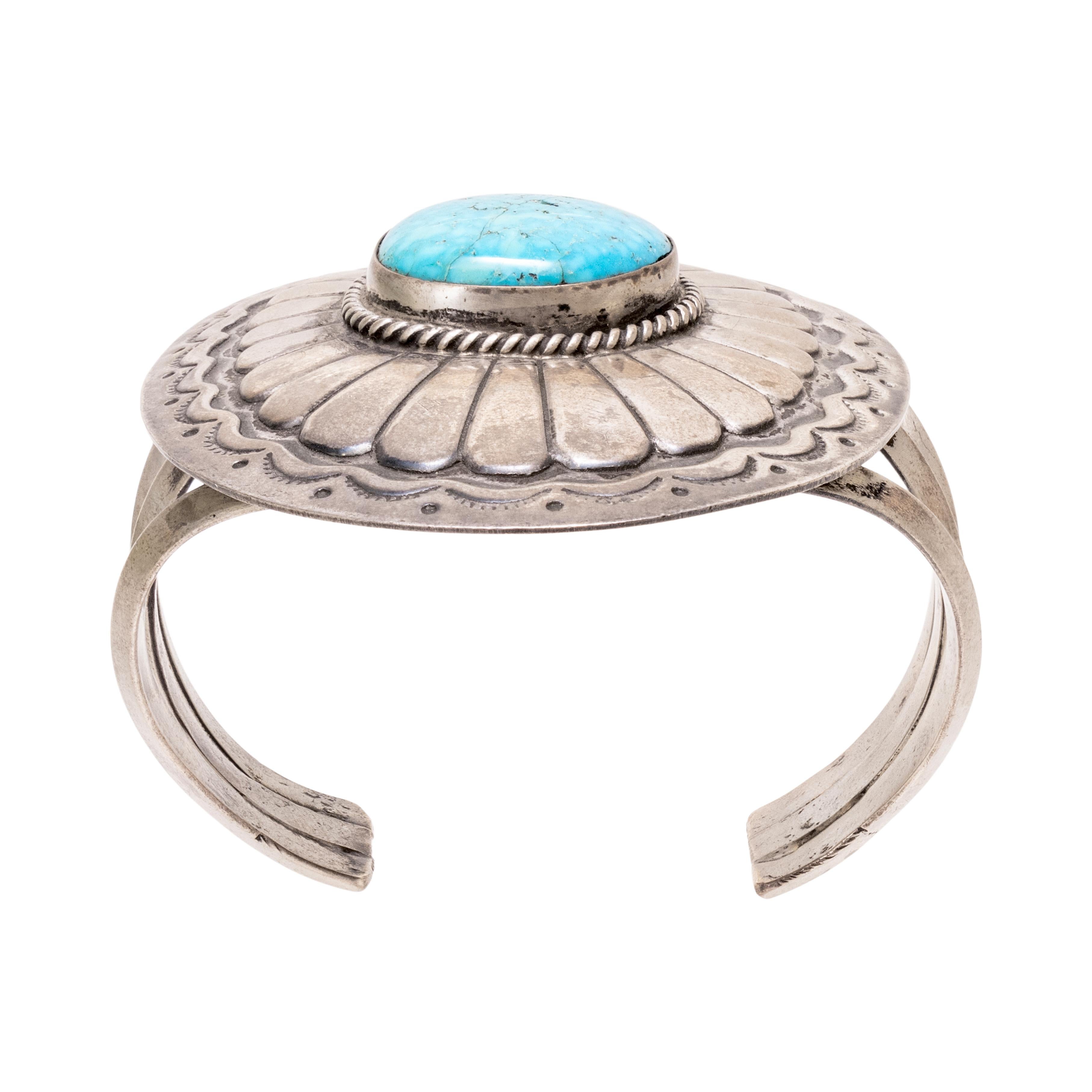 Navajo single-stone turquoise concho cuff bracelet. Old Pawn. Stone is surrounded by twisted rope border and set in large sterling silver concho. Kingman turquoise stone is a beautiful bright blue with soft spider-webbed matrix. From the Indian