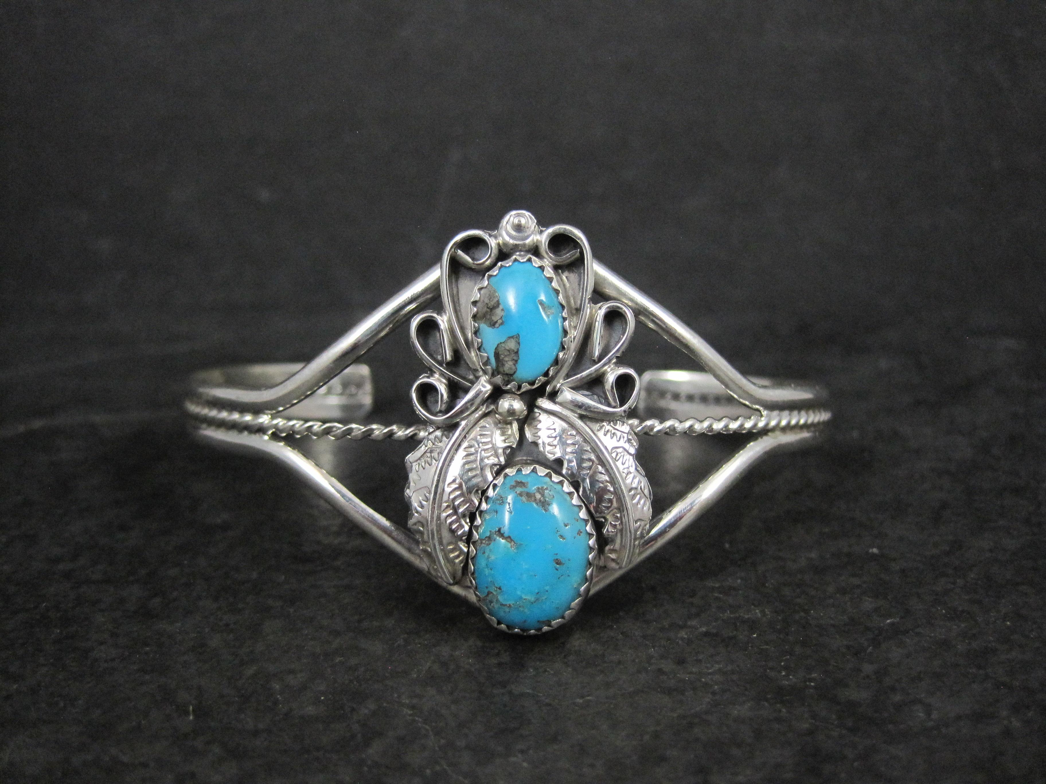 This gorgeous cuff bracelet is sterling silver with genuine turquoise gemstones.
It is the creation of Navajo silversmith Harry B Yazzie.

The face of this cuff bracelet measures 1 5/16 inches north to south.
It has an inner circumference of 6 1/4