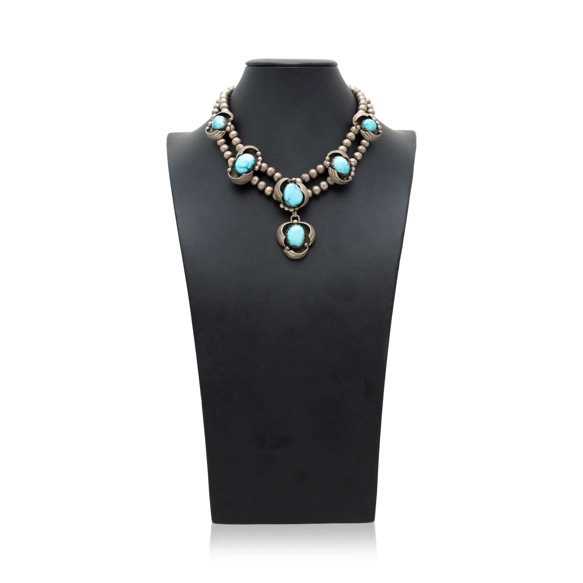 Double strand Navajo pearl sterling silver and Morenci turquoise necklace. Six high quality stones each encased in in sterling feather and bead design against shadowbox style background. Great patina. Stones are a bright sky blue, with veins of