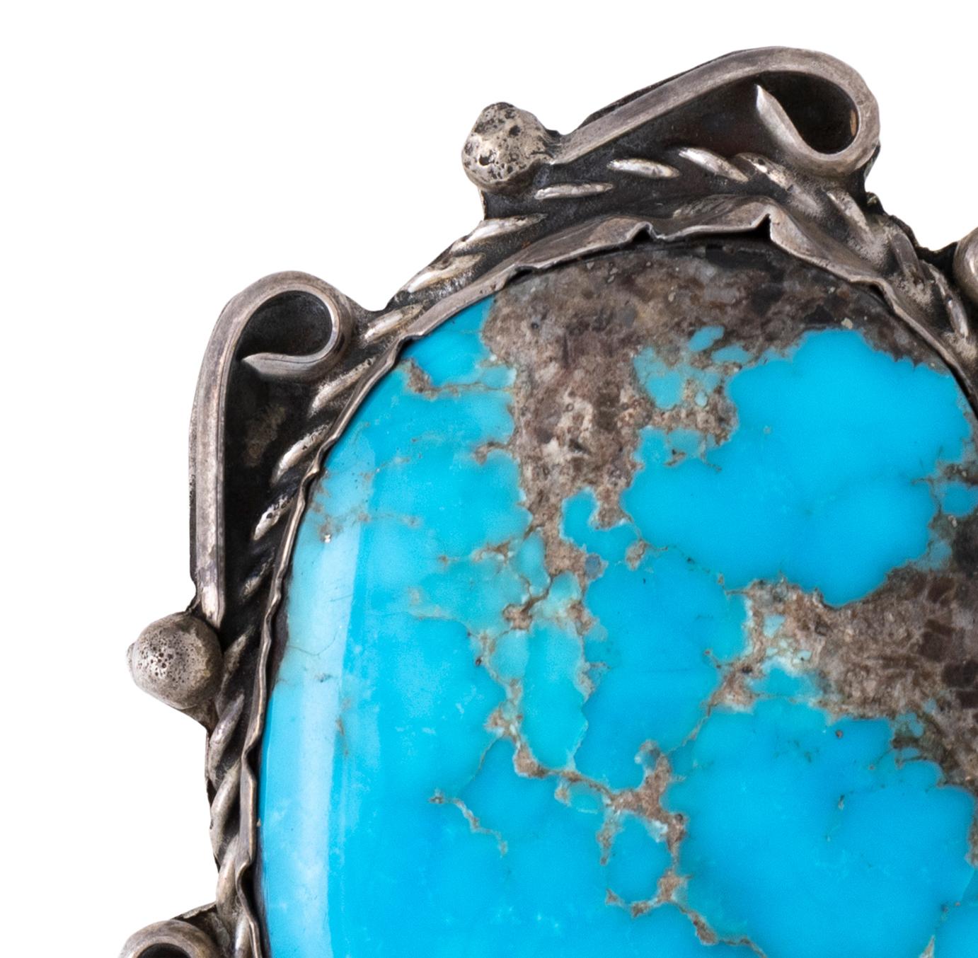 Large Navajo Blue Diamond turquoise pendant set in sterling silver with twisted rope border. Nice size stone, natural, untreated with great depth and patina. No maker's mark. Old Pawn. From the Indian Store in Clovis, New Mexico. Mid 20th century.