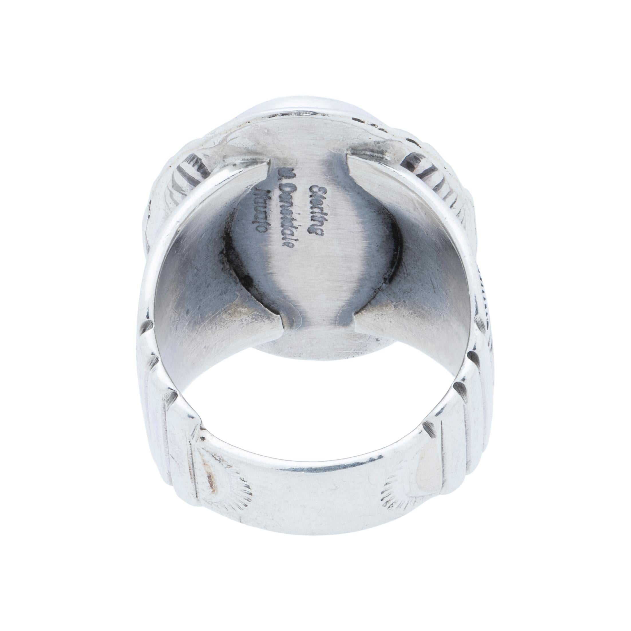Navajo sterling silver and Kingman turquoise ring. Natural, untreated stone atop a classic twisted rope border with slash marks and hand stamped palmettes that flow through the thick band. Made by Navajo Silversmith W. Will Denetdale and stamped
