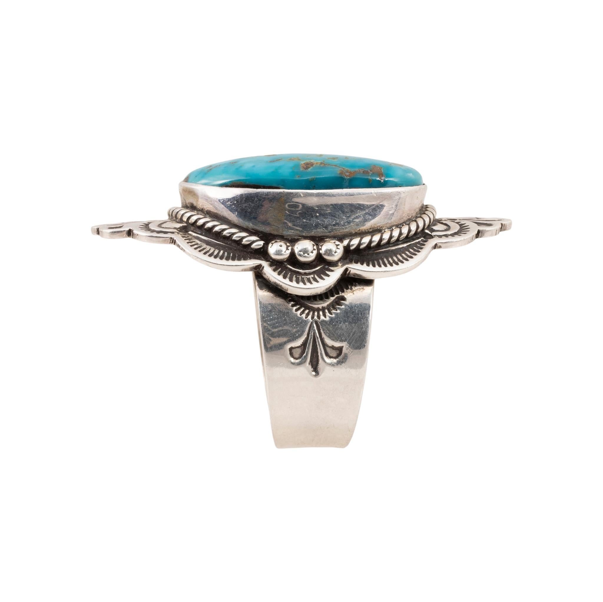 Navajo Morenci turquoise ring set in sterling silver with twisted rope border and palmette design. Makers mark 
