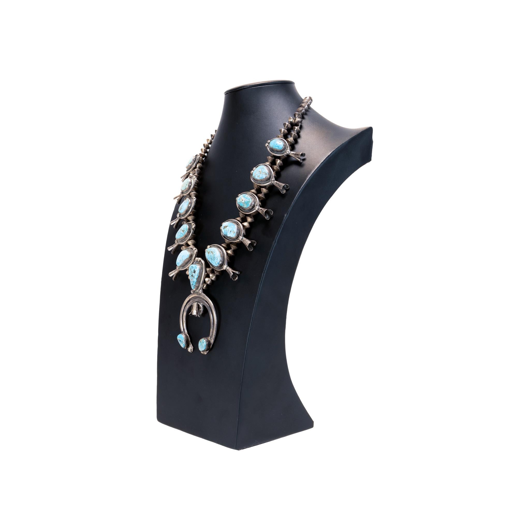 Navajo old pawn Morenci turquoise and sterling silver squash blossom. 11 natural stones in twisted rope and shadow box border ending in a two stone sand cast naja. Stones are a great example of Morenci, having light blue color with brown and silver