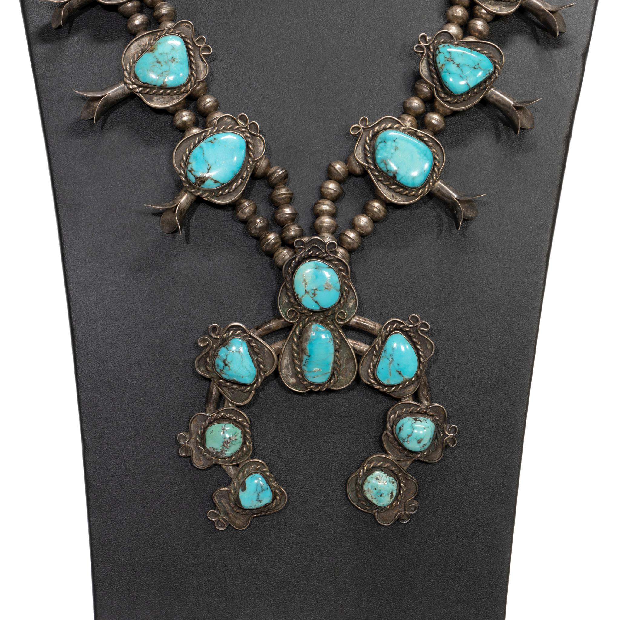 Navajo sterling silver and turquoise squash blossom necklace. 18 exceptional Kingman turquoise stones set in shadow box with twisted rope border. Great patina that can be buffed out easily if preferred. Old Pawn. Acquired from an individual who