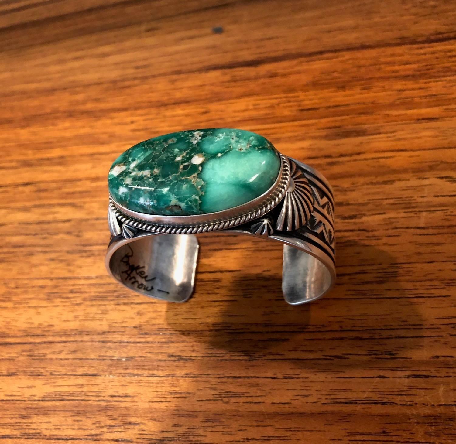 This fabulous cuff bracelet is handmade by Navajo silversmith Delbert Gordon featuring a rare green variquoise turquoise spider web slab stone from the Broken Arrow Mine in Nevada.

The bracelet is gorgeous, heavy and solid made of sterling silver
