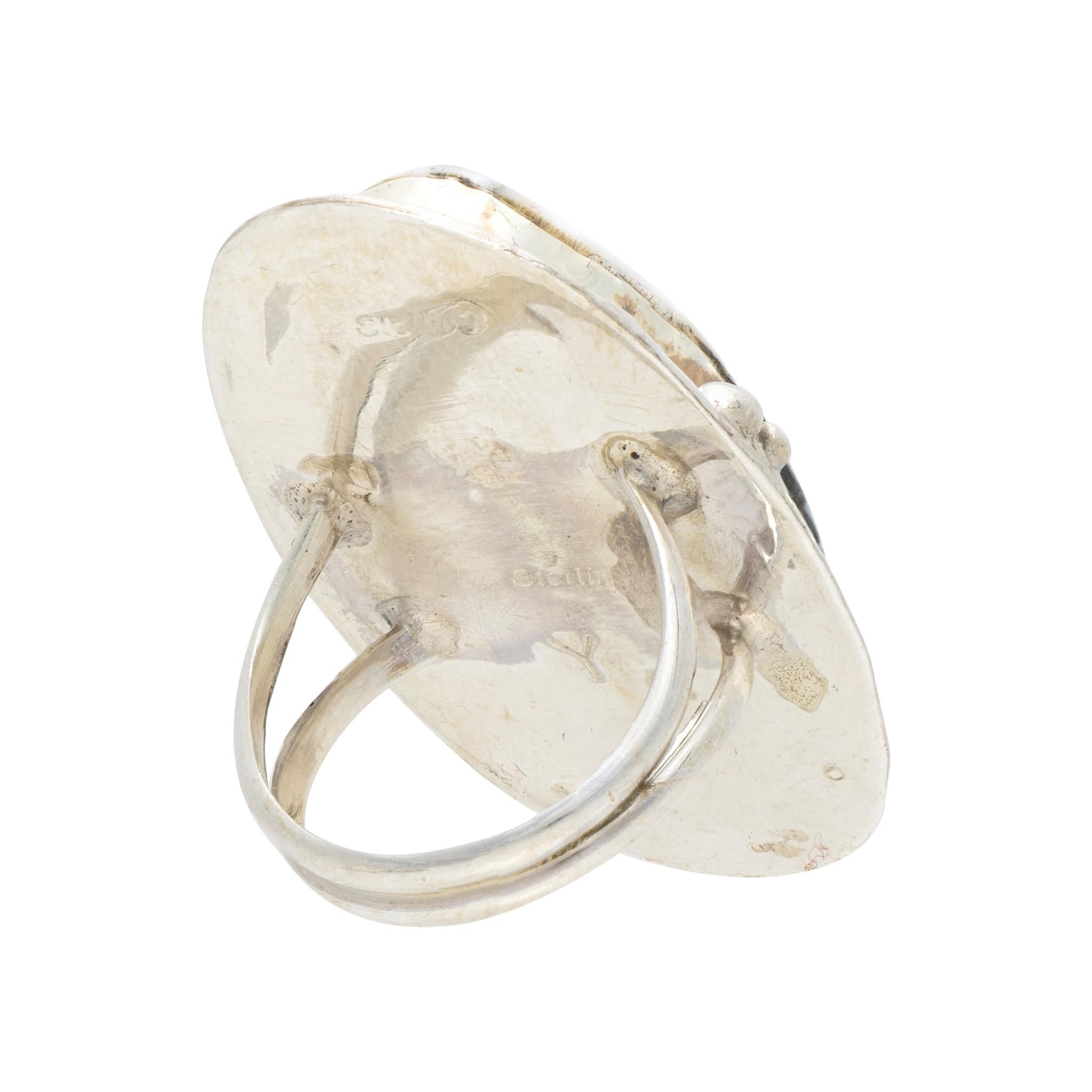 Native American Navajo Indian white buffalo turquoise ring set in sterling silver. Large center stone surrounded by classic twisted rope border having hand stamped palmettes. Maker's initials 